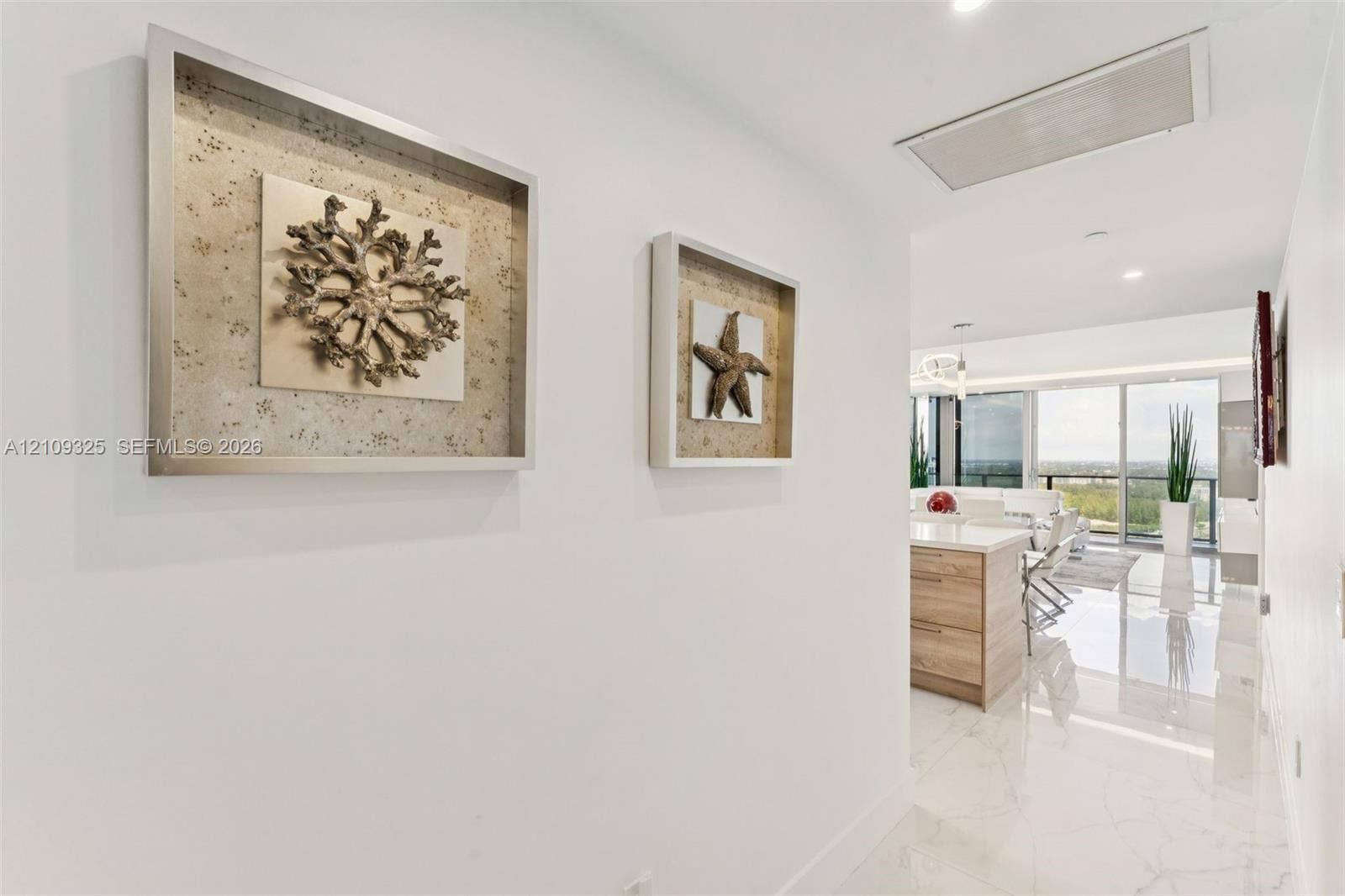 Polished stone flooring, recessed lighting, and expansive floor-to-ceiling glass panel doors