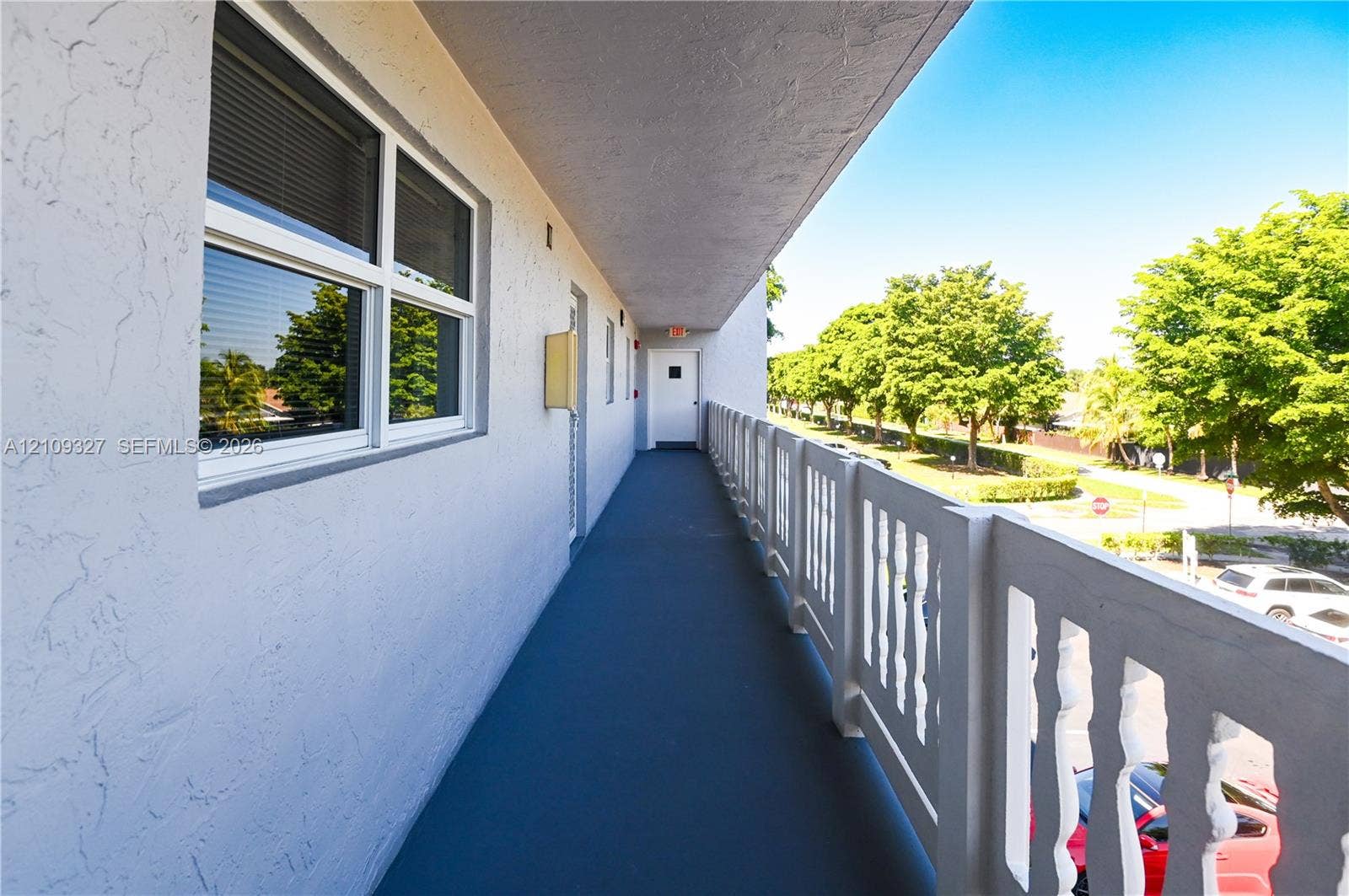 Exterior walkway featuring a covered corridor