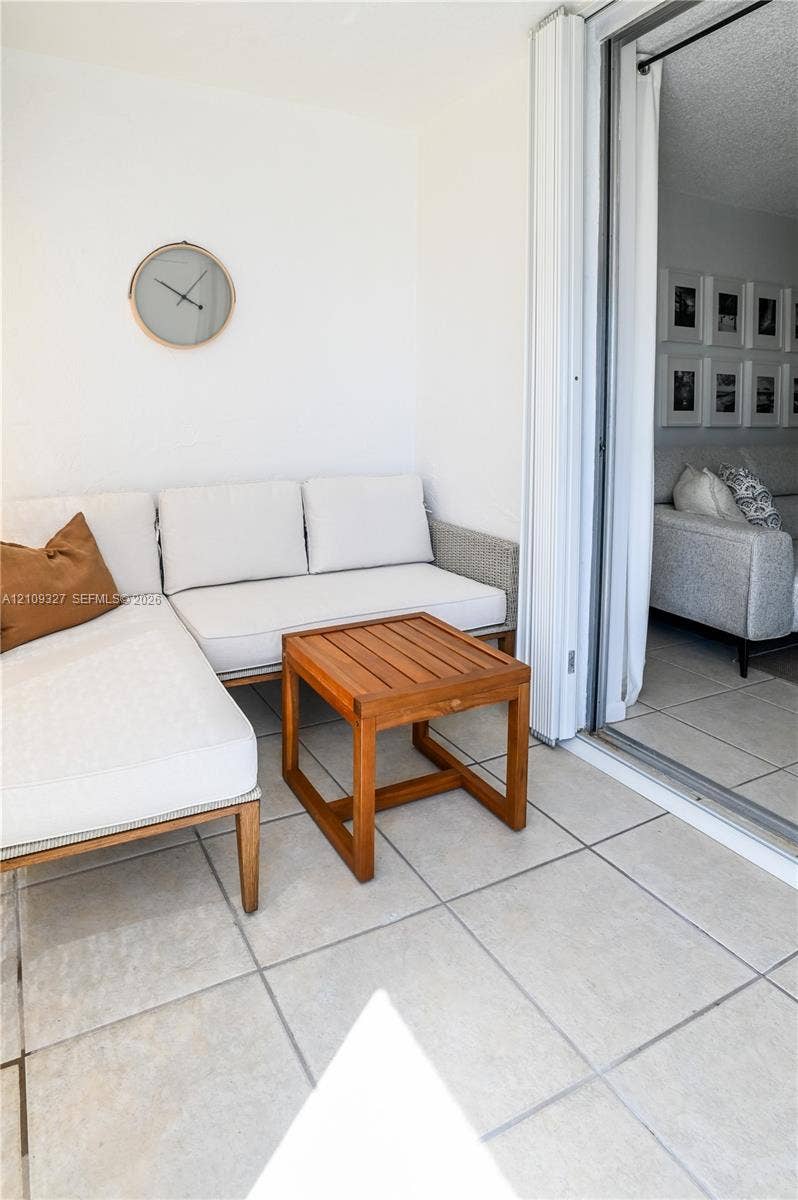 Balcony featuring large-format ceramic tile flooring and floor-to-ceiling sliding glass doors