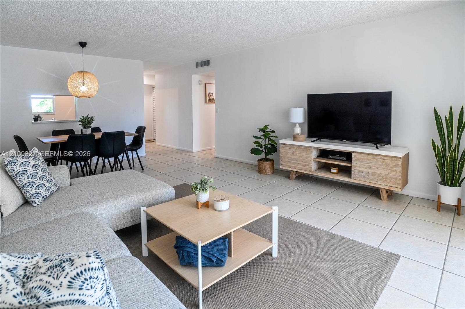 Open-concept interior featuring large-format tile flooring