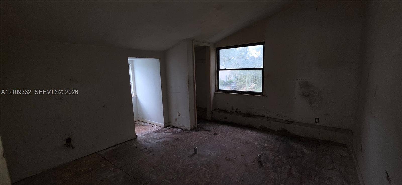 Interior space featuring a vaulted ceiling, single-hung window, and dedicated alcove area