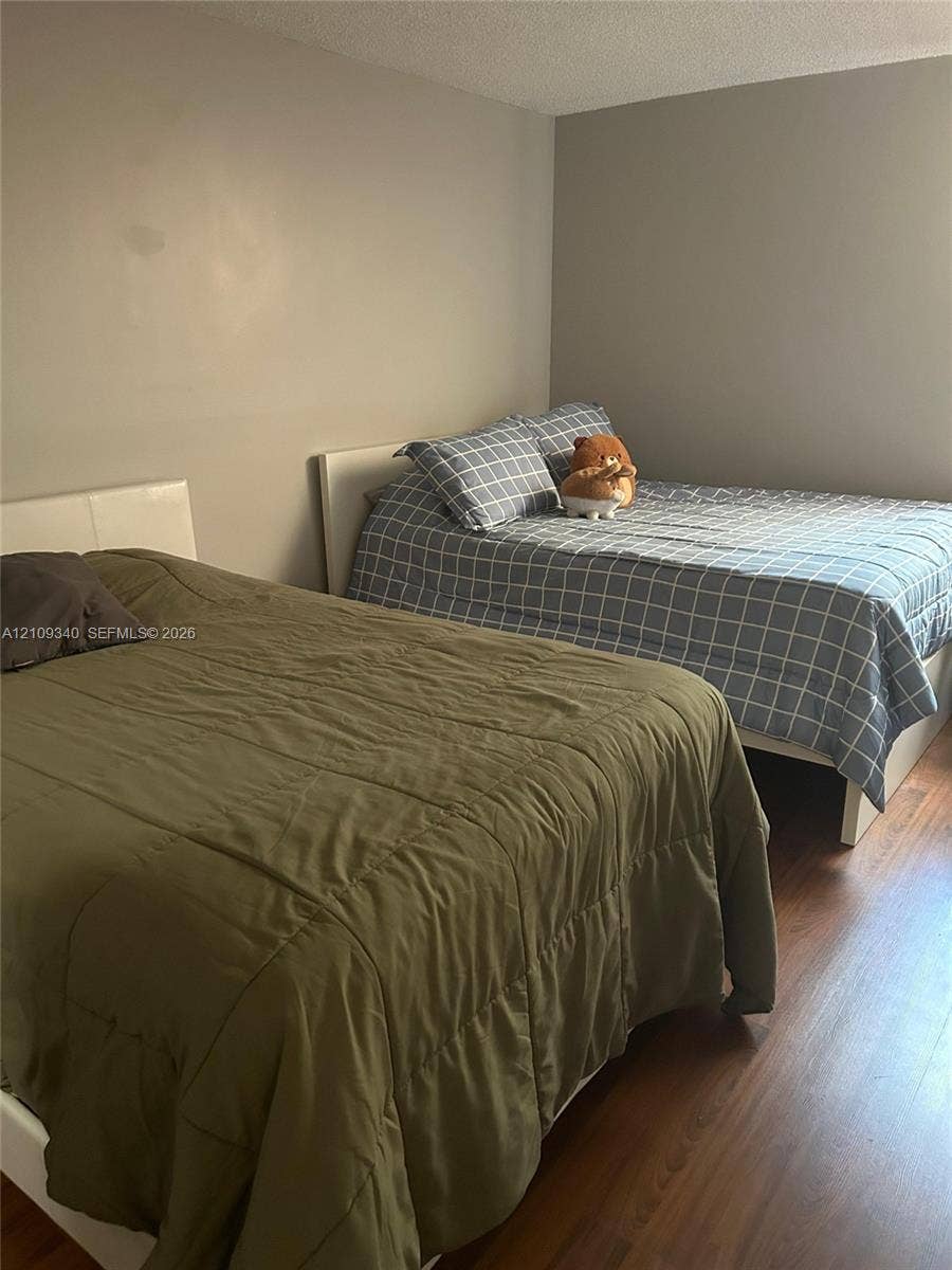 Room featuring neutral-toned walls and wood-finish flooring