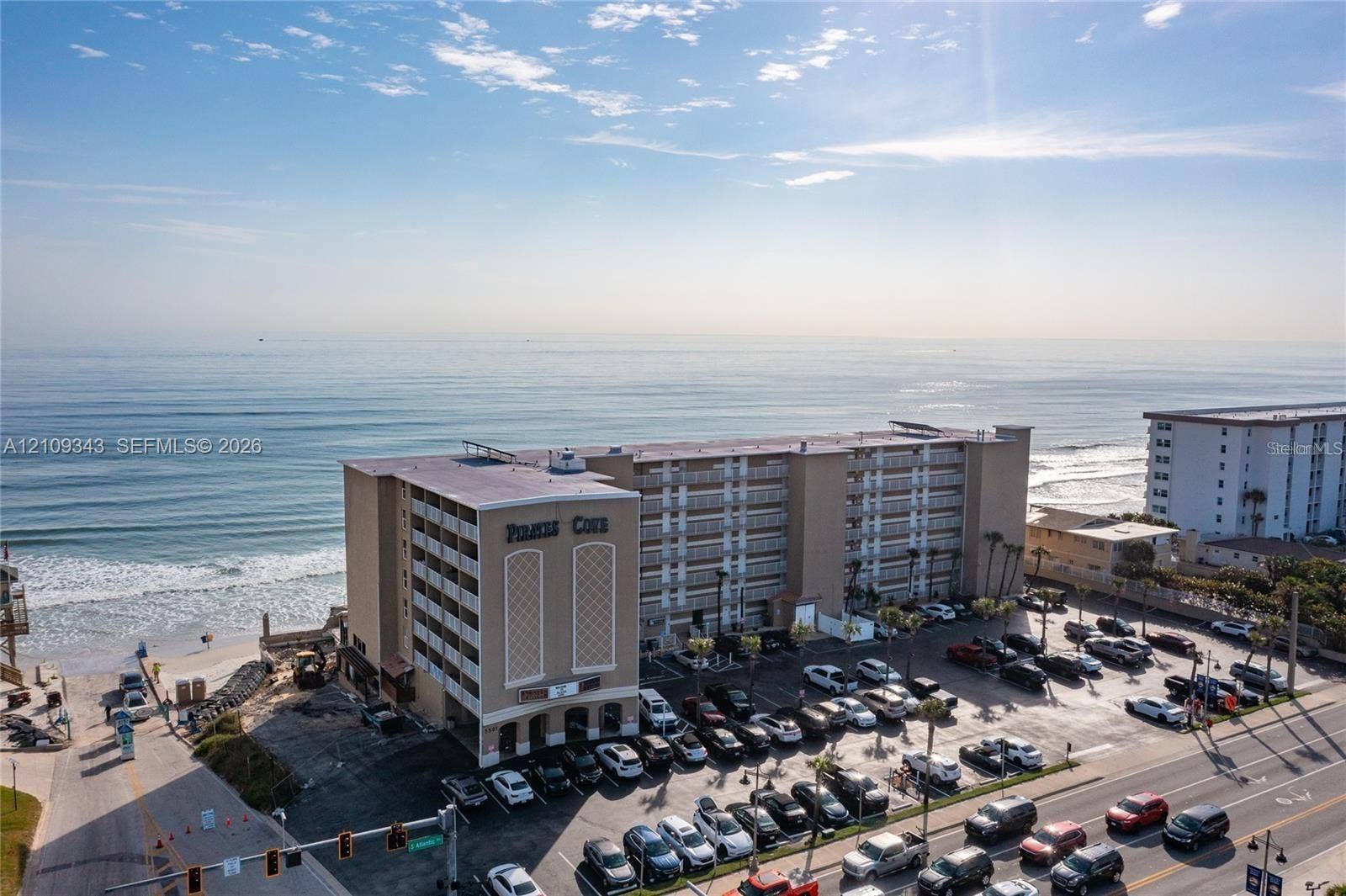 Multi-story oceanfront residential building featuring private balcony access and direct beach proximity