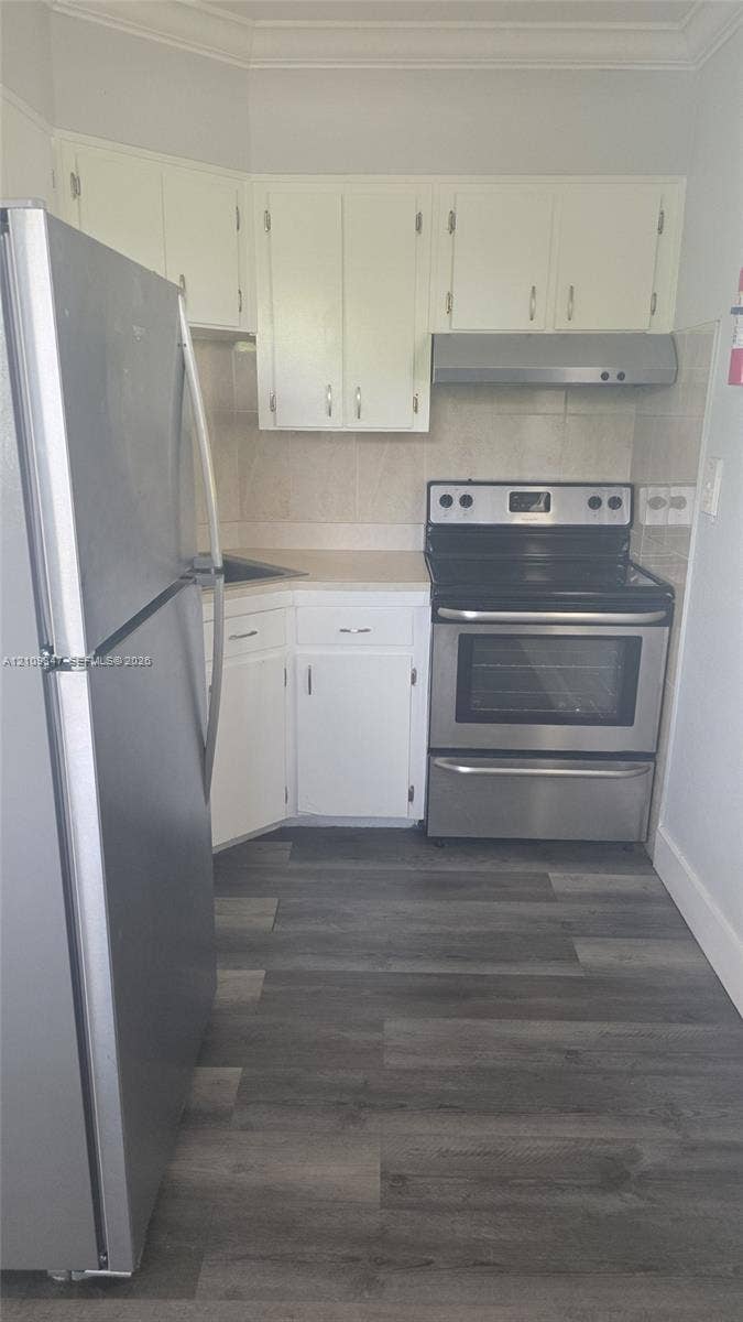 3128 SW 12th Place, #1-4, Fort Lauderdale, Fort Lauderdale, FL 33312 Kitchen featuring white cabinetry, wood-finish flooring, stainless steel freestanding range, stainless steel refrigerator, and integrated range hood