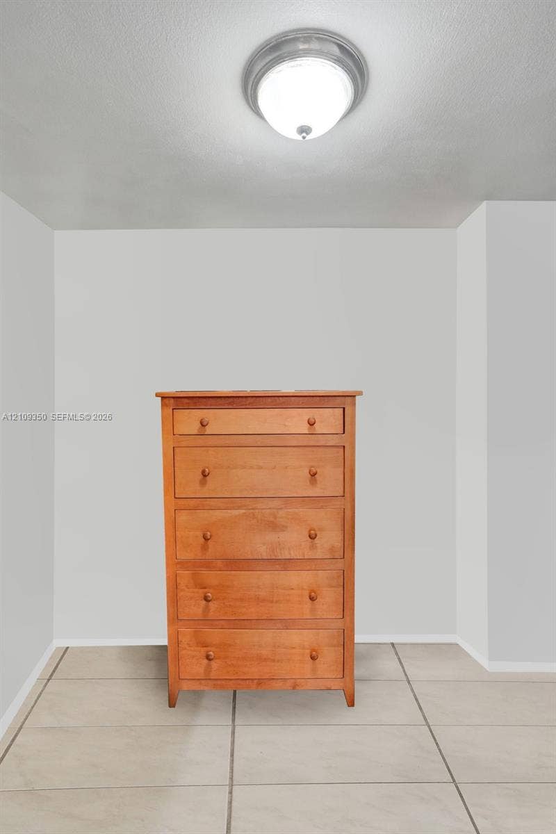 10777 W Sample Road, #616, Coral Springs, FL 33065 Neutral wall finishes, flush-mount circular ceiling lighting, and tile flooring