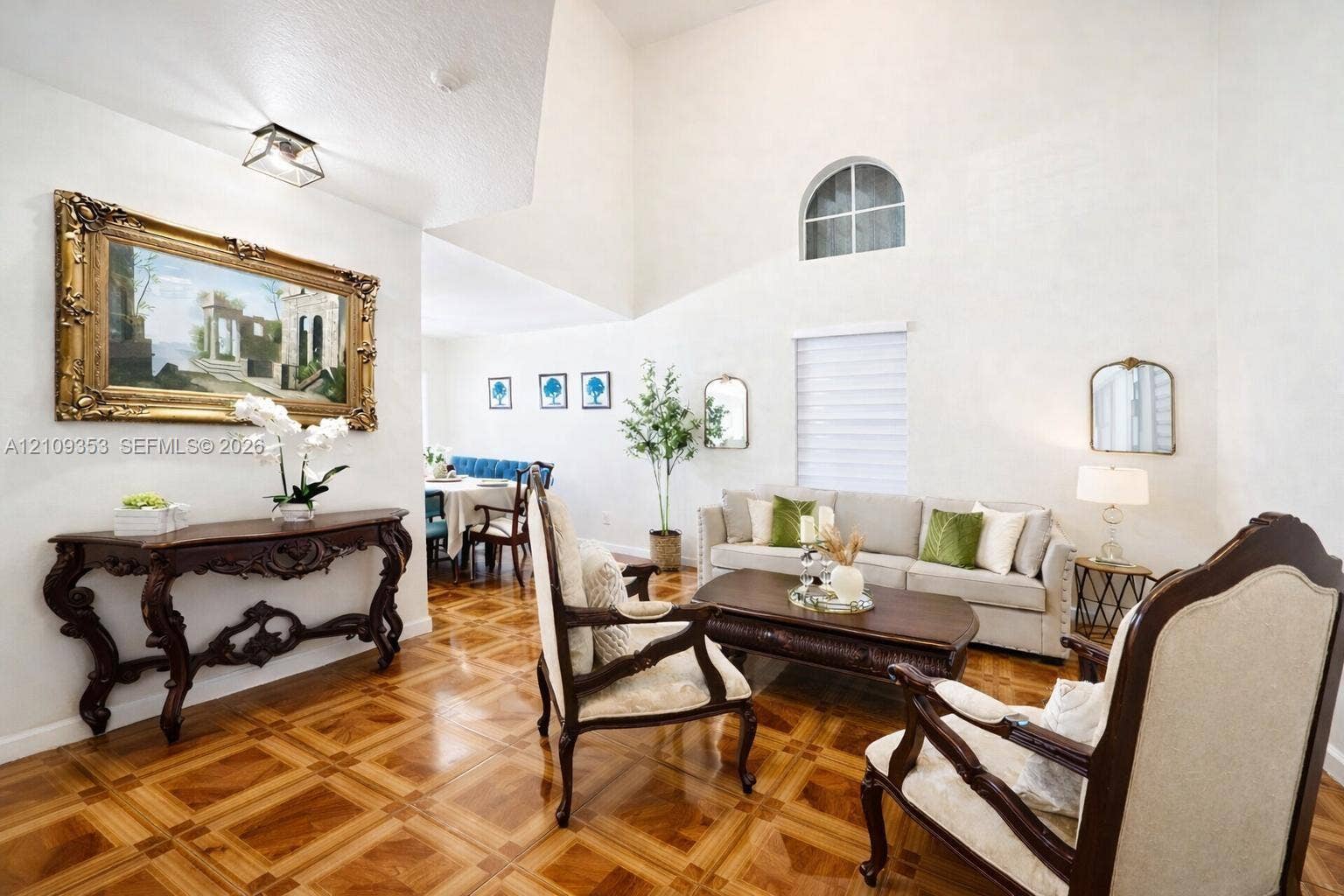 Vaulted ceilings, parquet flooring, and an arched window accent