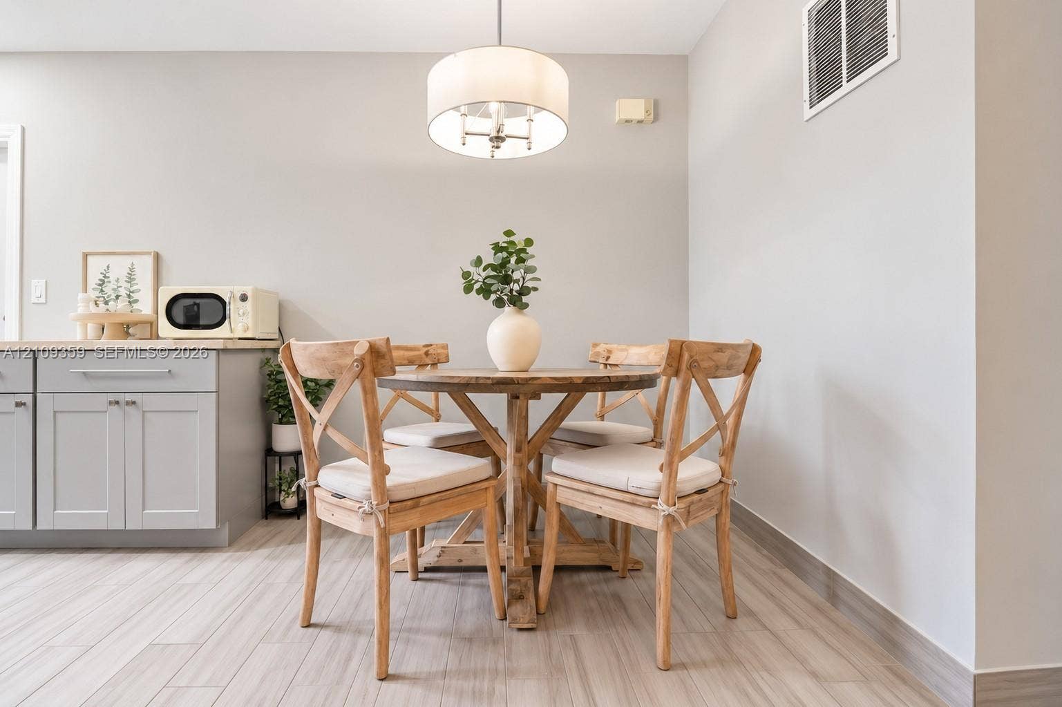 2426 SE 17th Causeway, #103A, Fort Lauderdale, FL 33316 Light gray cabinetry with stone-finish countertops, tile flooring, and a drum-style pendant light fixture