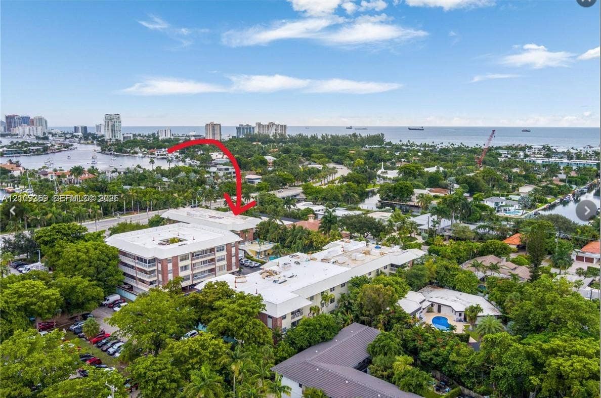 2426 SE 17th Causeway, #103A, Fort Lauderdale, FL 33316 Aerial perspective of a multi-story residential building featuring concrete construction, flat roofline, and integrated surface parking