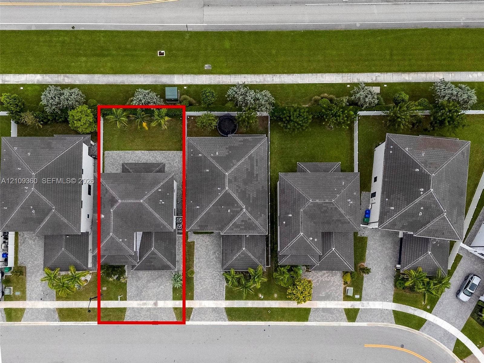 4535 SW 173rd Avenue, Miramar, FL 33029 Aerial view of a residential property featuring a dark-toned hipped roof, paver driveway, and rear lawn area