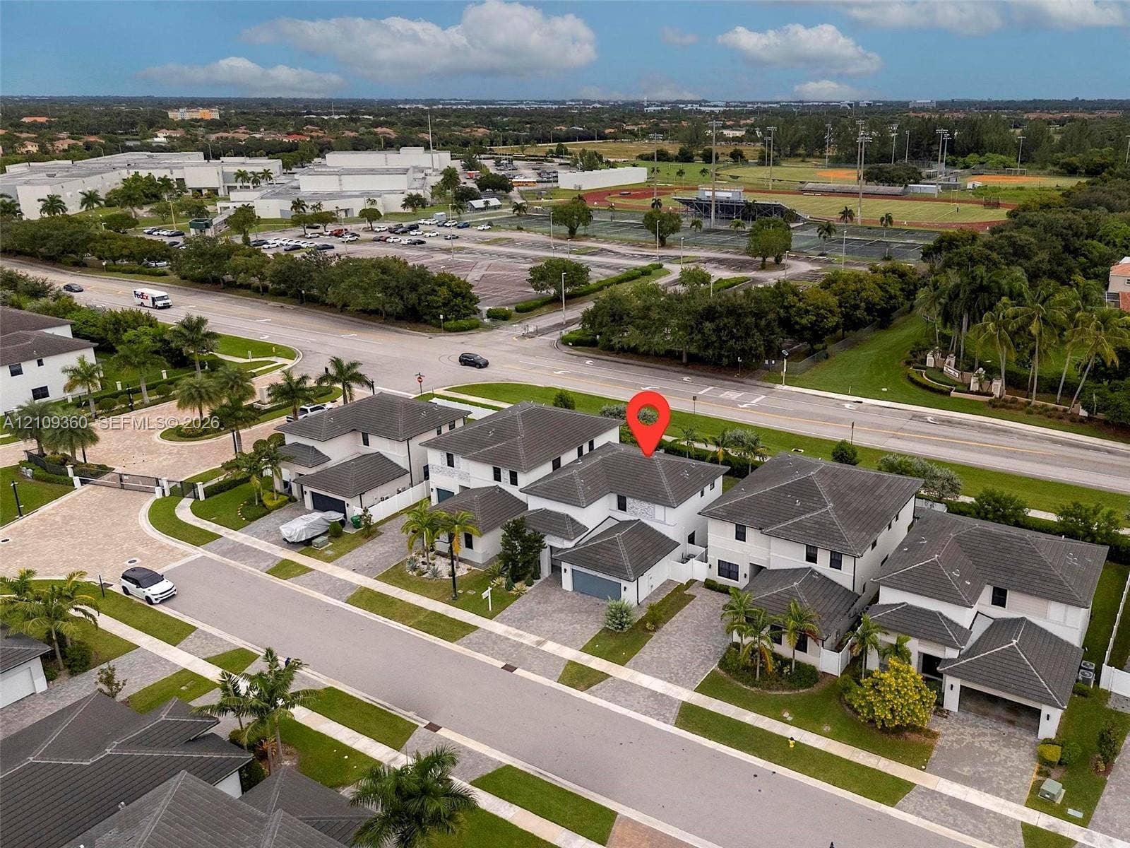 4535 SW 173rd Avenue, Miramar, FL 33029 Multi-level residence featuring a concrete tile roof, light-toned exterior finish, and a paver driveway leading to a multi-car garage