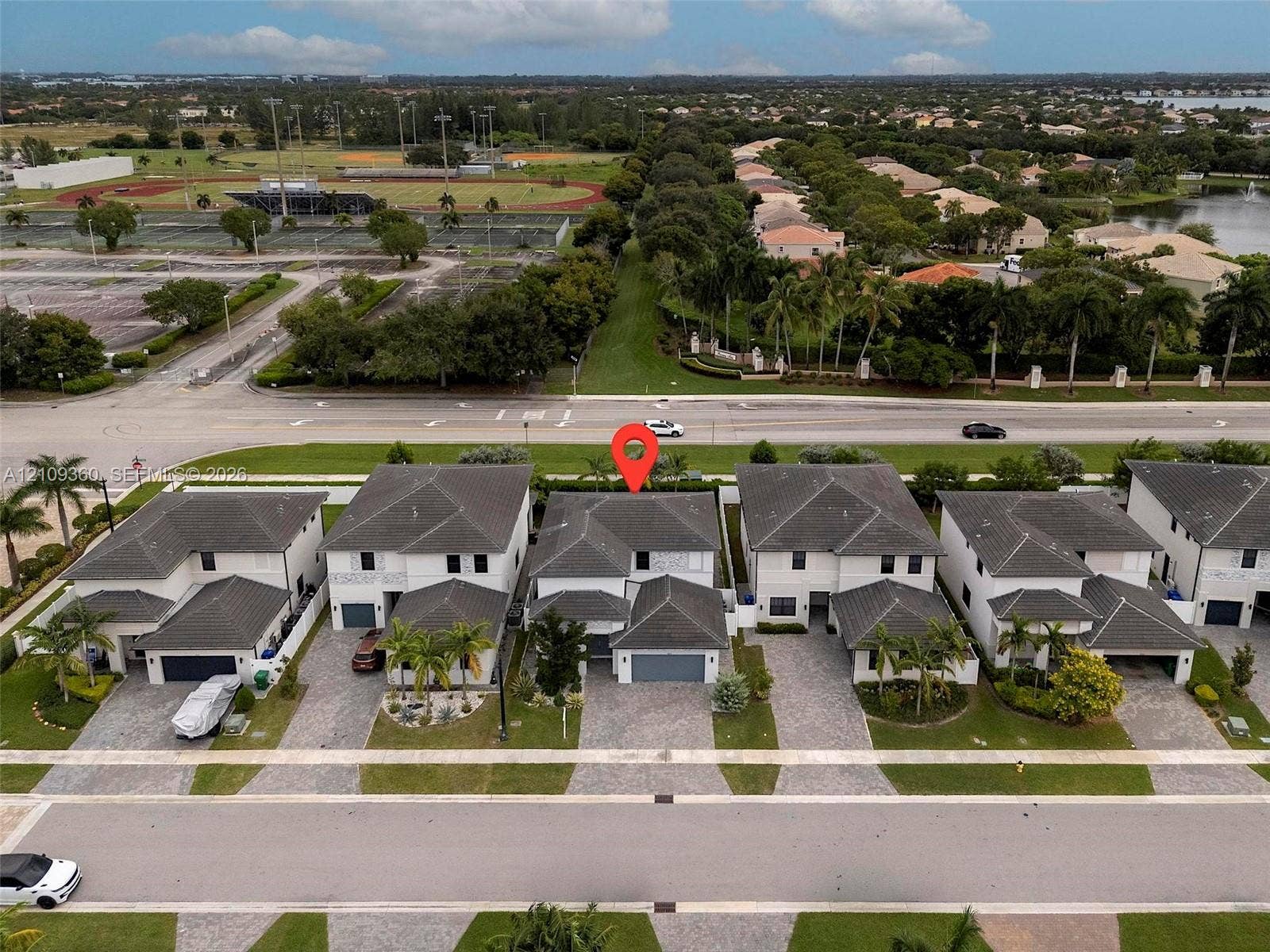 4535 SW 173rd Avenue, Miramar, FL 33029 Aerial perspective of a two-story residence featuring a hip roof design, paver driveway, and an attached two-car garage