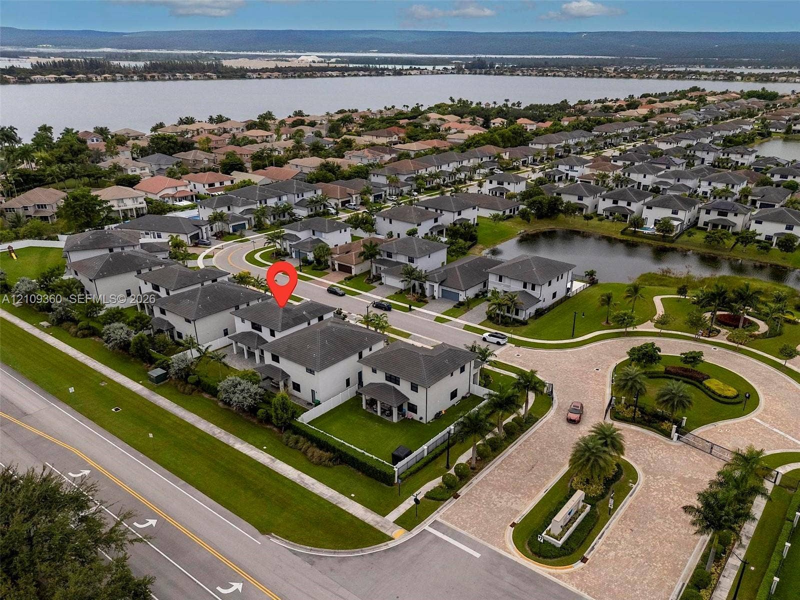4535 SW 173rd Avenue, Miramar, FL 33029 Aerial perspective of residential property featuring a multi-story exterior, attached garage, fenced perimeter, and proximity to expansive water frontage