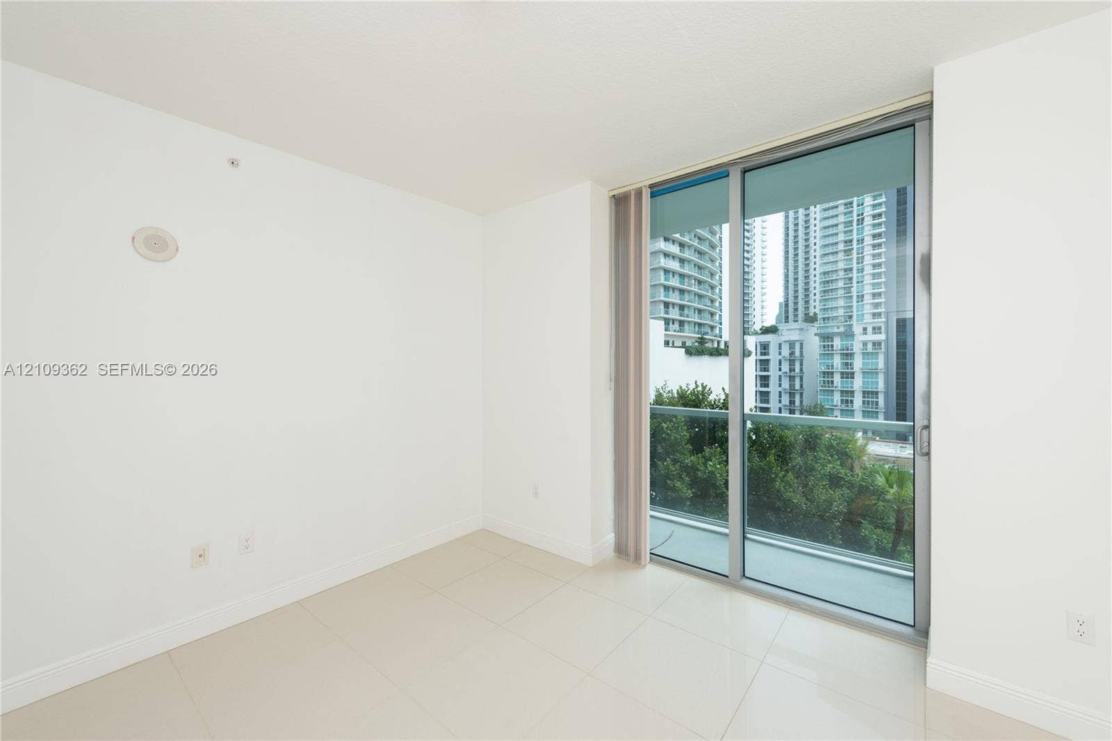 79 SW 12th Street, #1107-S, Miami, FL 33130 Floor-to-ceiling glass sliding door, porcelain tile flooring, and metallic frame balcony enclosure