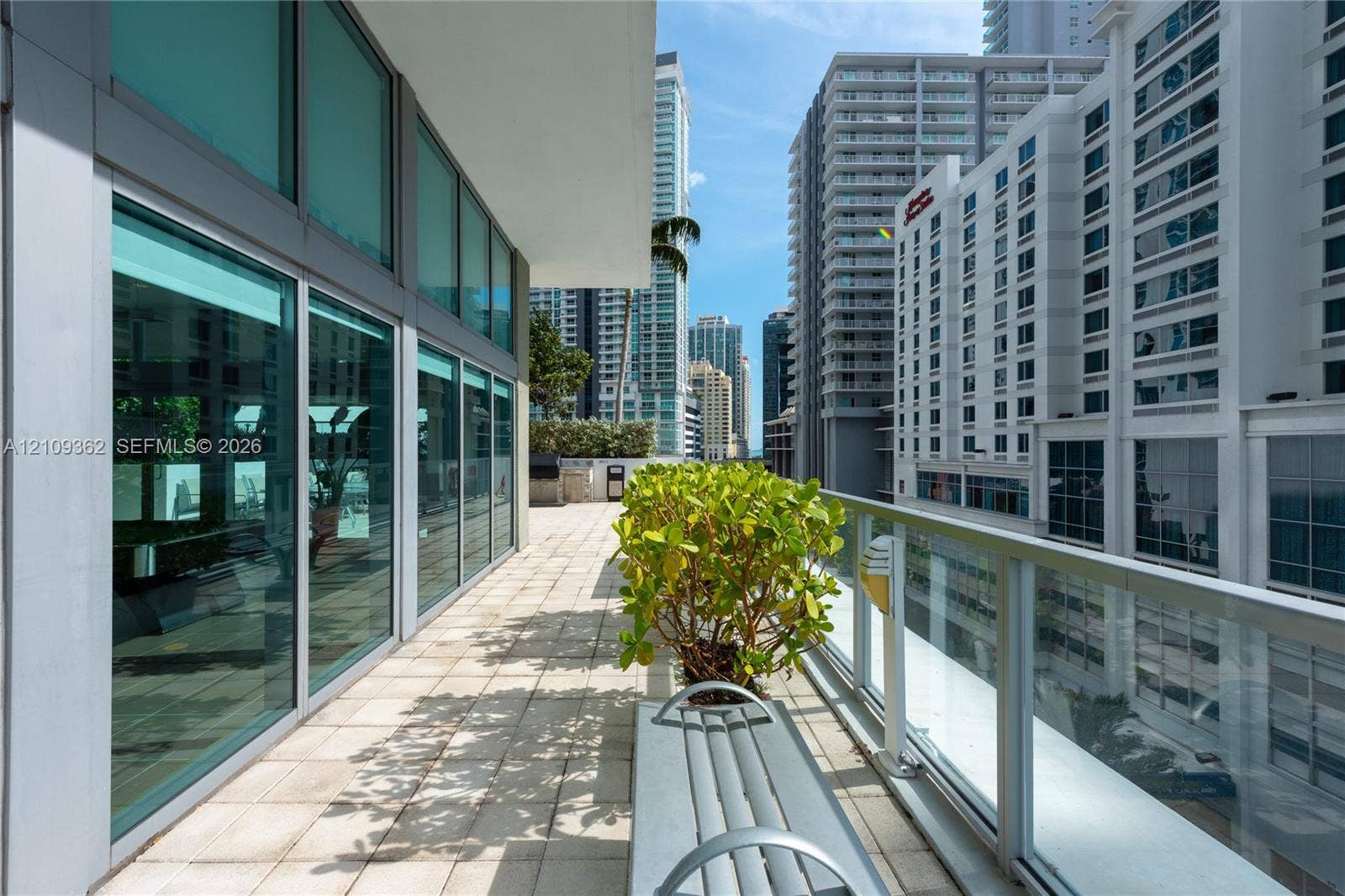 79 SW 12th Street, #1107-S, Miami, FL 33130 Expansive balcony featuring floor-to-ceiling glass paneling, tile flooring, and a glass-paneled railing