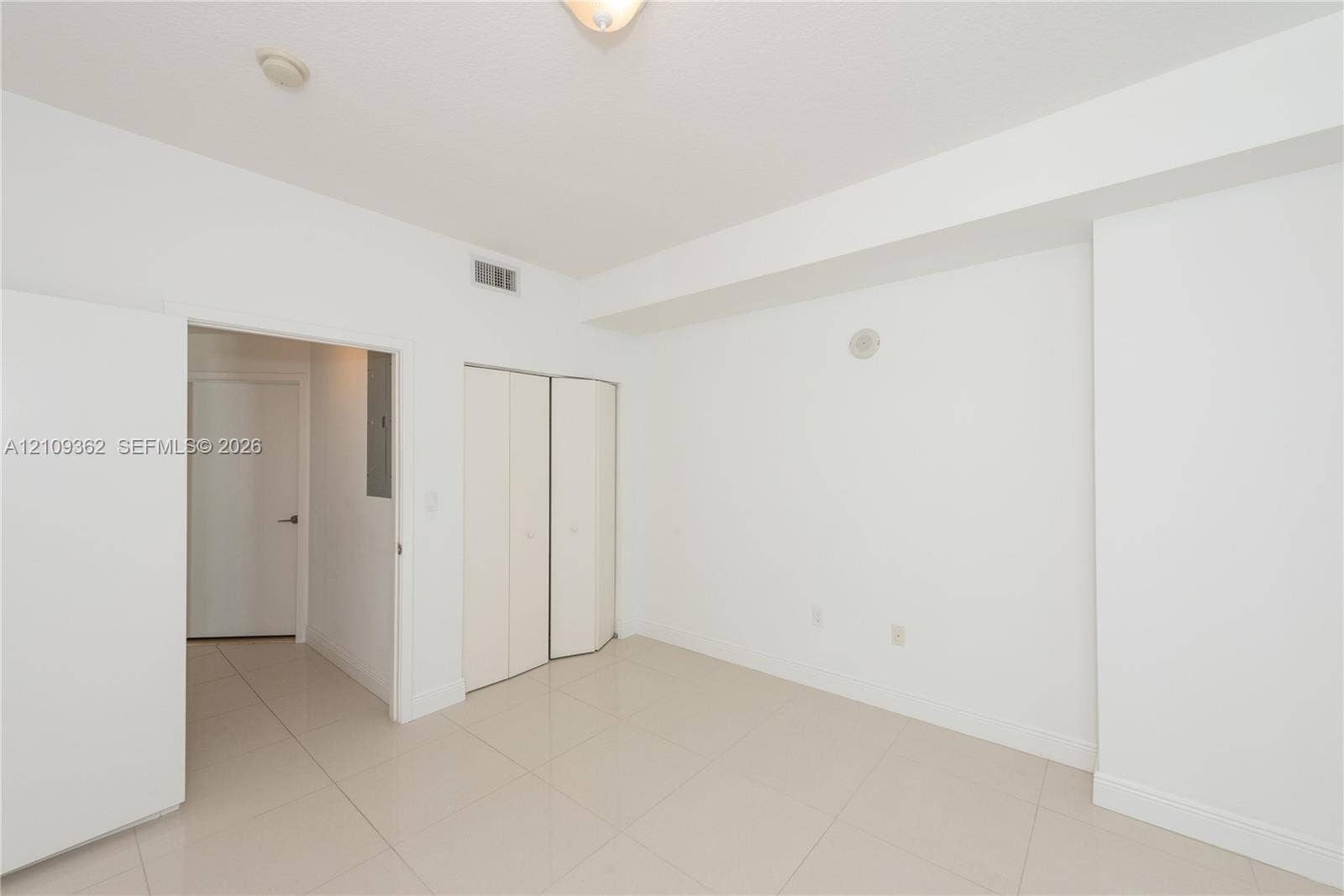 79 SW 12th Street, #1107-S, Miami, FL 33130 Neutral interior featuring tile flooring, smooth ceiling, and built-in closet with double-panel doors
