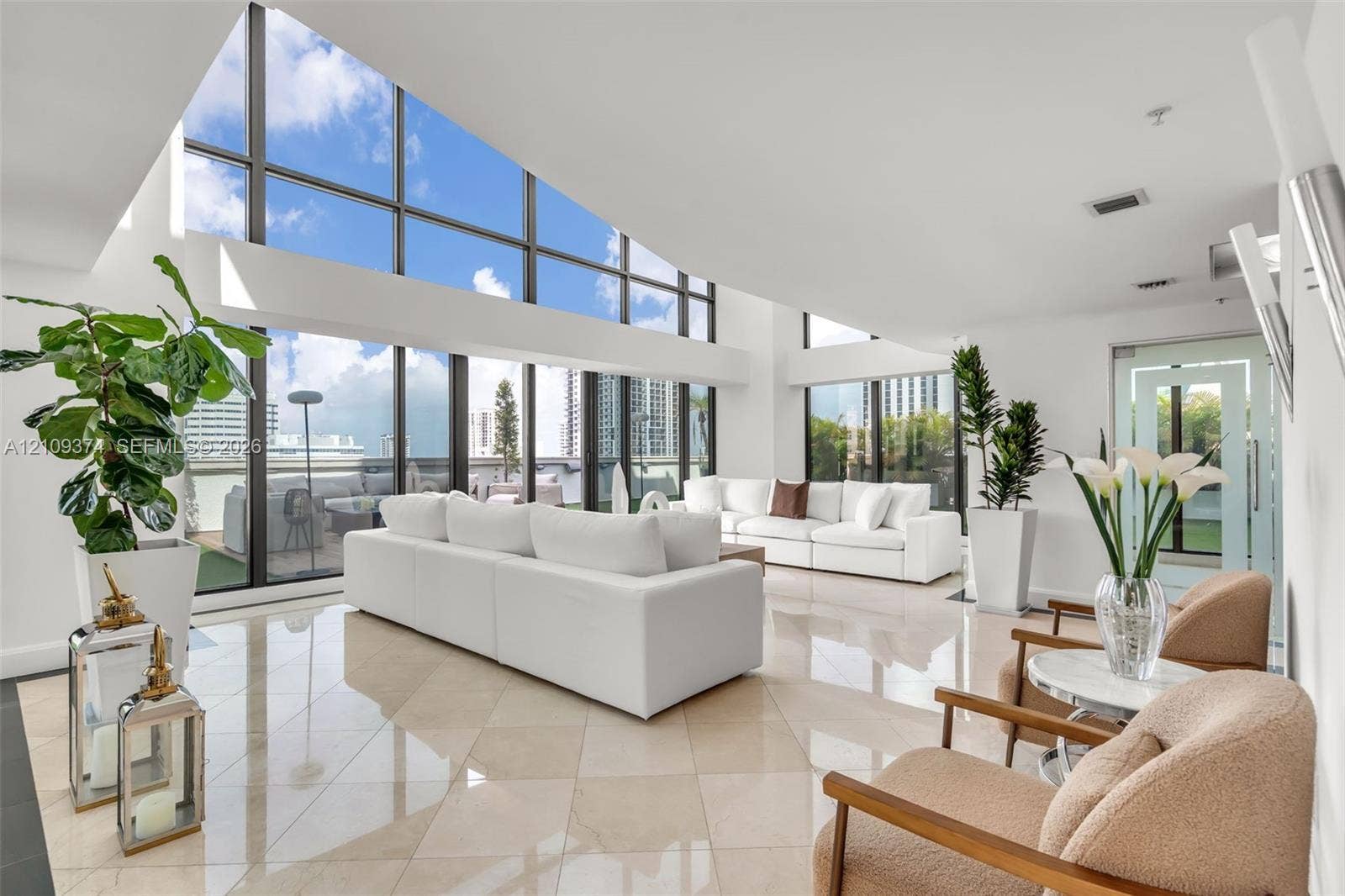 100 N Federal Highway, #1, Fort Lauderdale, FL 33301 Vaulted ceilings featuring expansive floor-to-ceiling windows and polished stone tile flooring