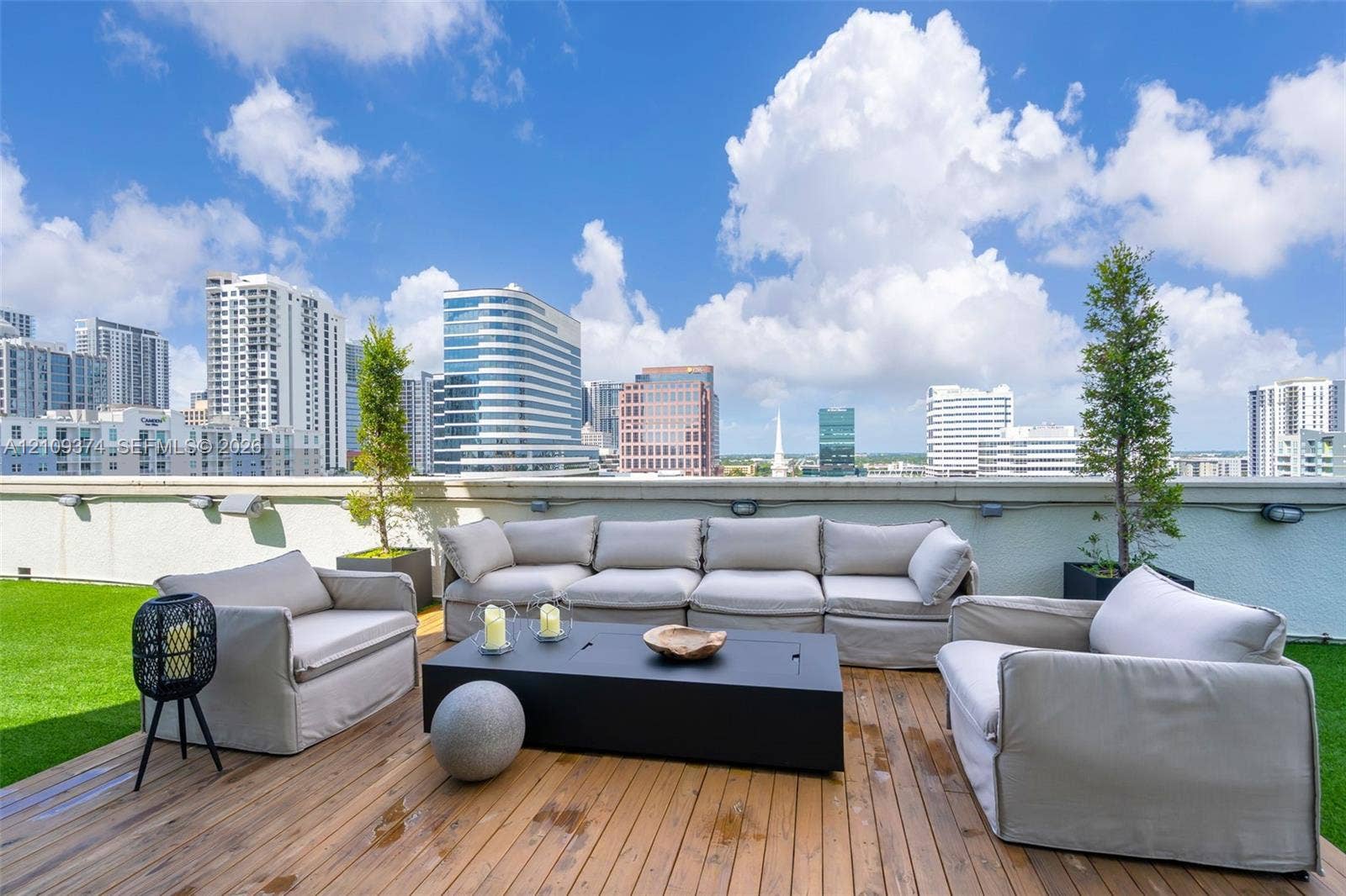 100 N Federal Highway, #1, Fort Lauderdale, FL 33301 Expansive rooftop terrace featuring wood-plank decking, synthetic turf, integrated wall-mounted lighting, and panoramic urban skyline scenery