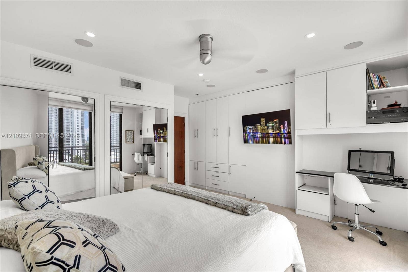 100 N Federal Highway, #1, Fort Lauderdale, FL 33301 Built-in floor-to-ceiling cabinetry, recessed lighting, integrated desk workspace, mirrored closet doors, and flush-mount ceiling fan