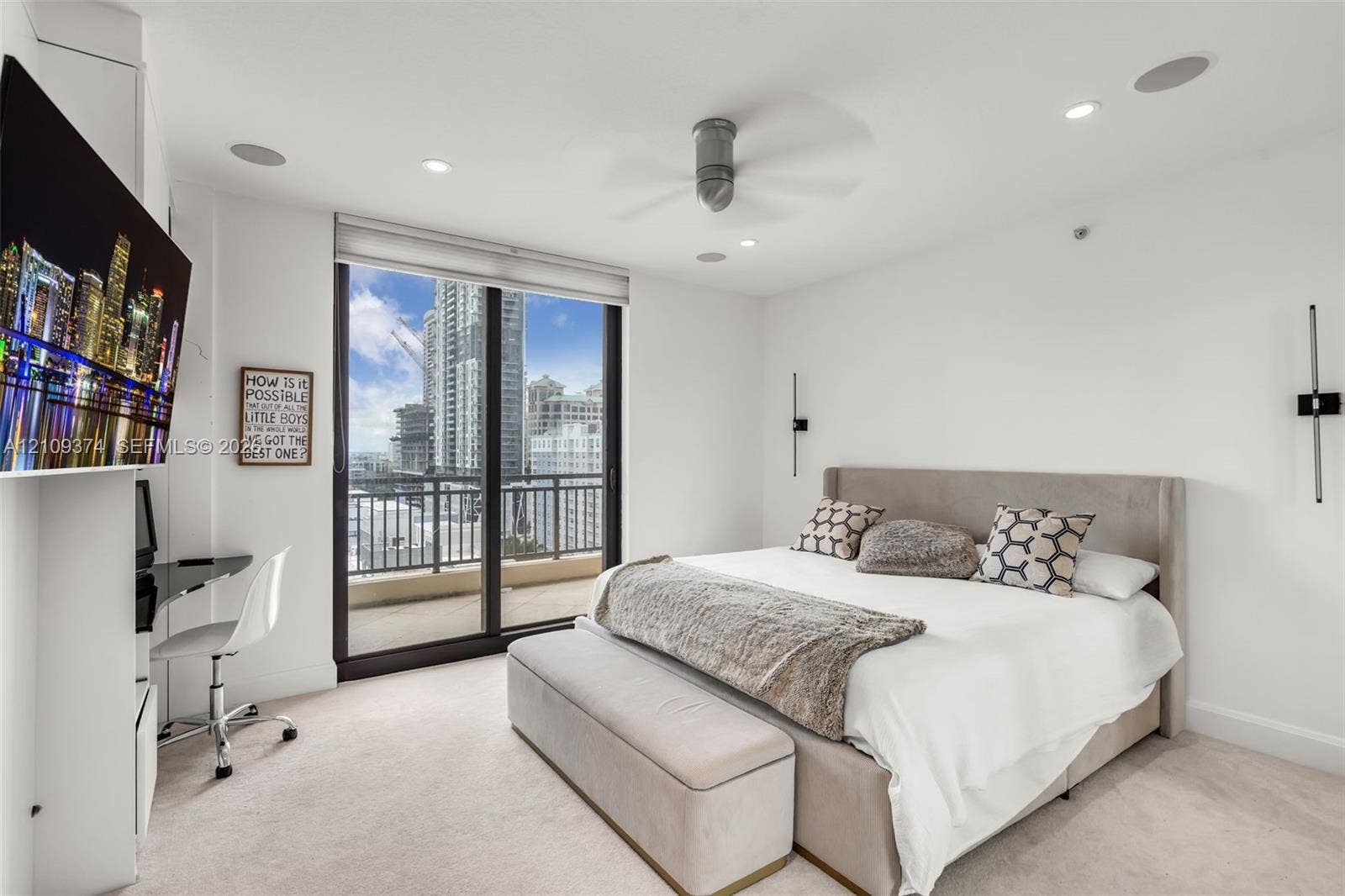 100 N Federal Highway, #1, Fort Lauderdale, FL 33301 Floor-to-ceiling glass sliding doors, private balcony, recessed lighting, ceiling fan, and wall-mounted light fixtures