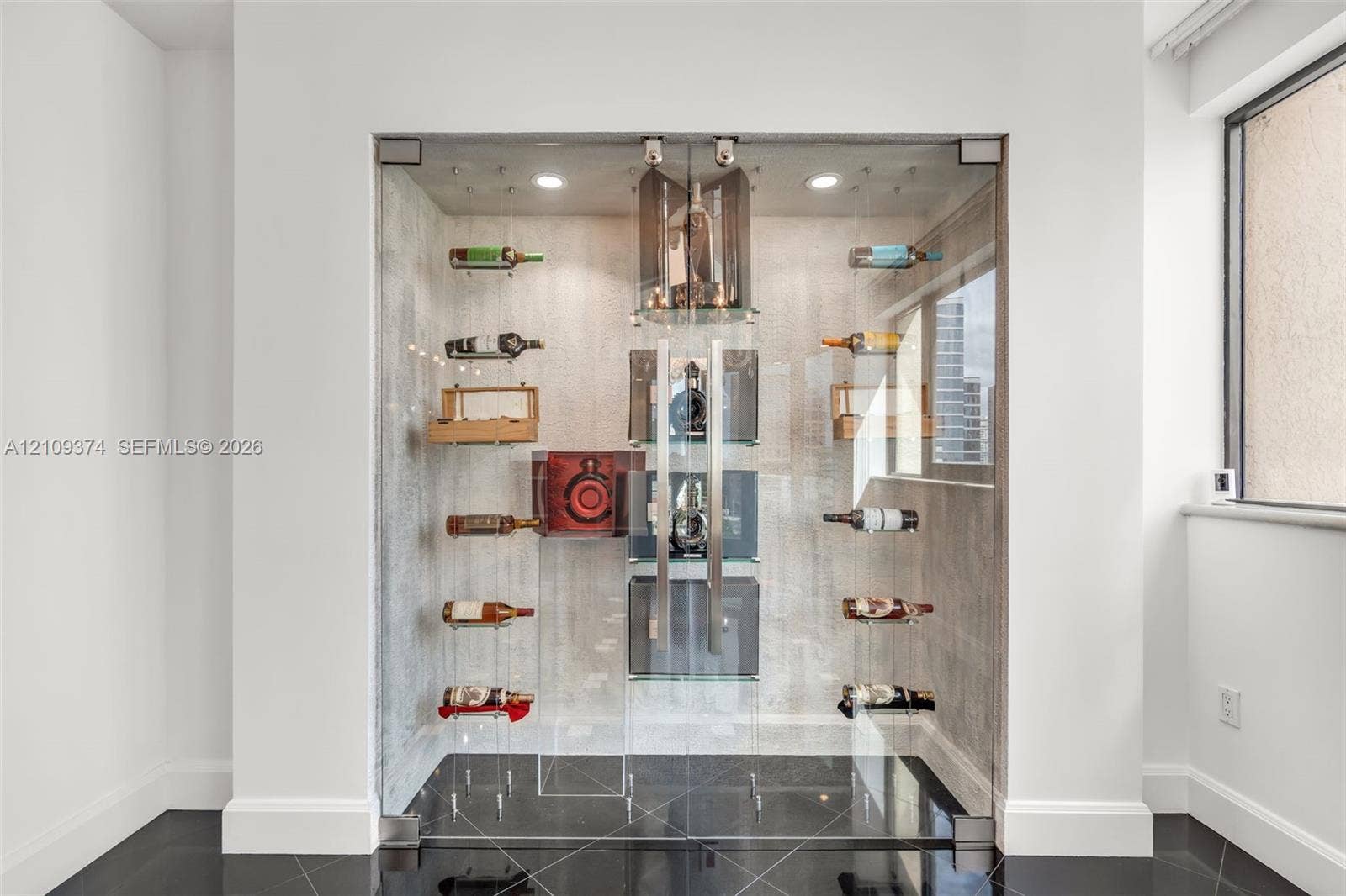 100 N Federal Highway, #1, Fort Lauderdale, FL 33301 Custom climate-controlled display enclosure featuring floor-to-ceiling glass paneling, metal racking systems, integrated recessed lighting, and high-gloss tile flooring