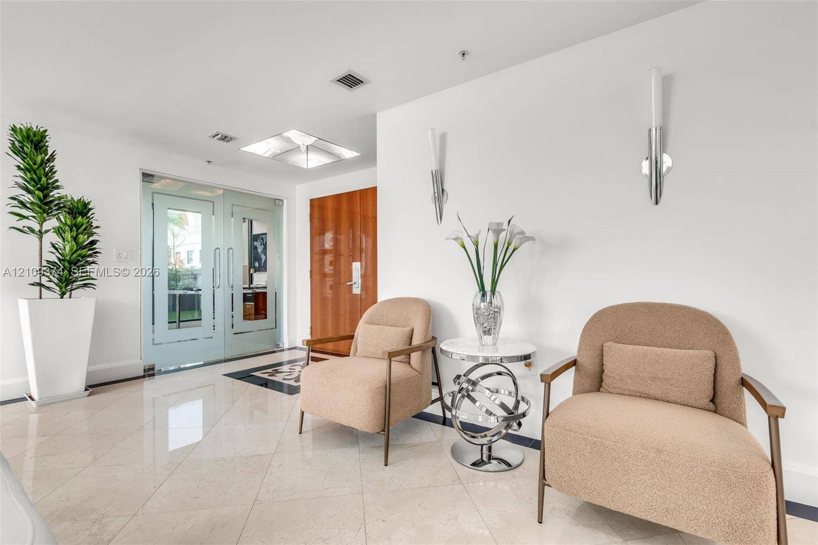 100 N Federal Highway, #1, Fort Lauderdale, FL 33301 Polished stone flooring, dual glass-paneled entry doors, recessed ceiling lighting, and contemporary wall-mounted light fixtures