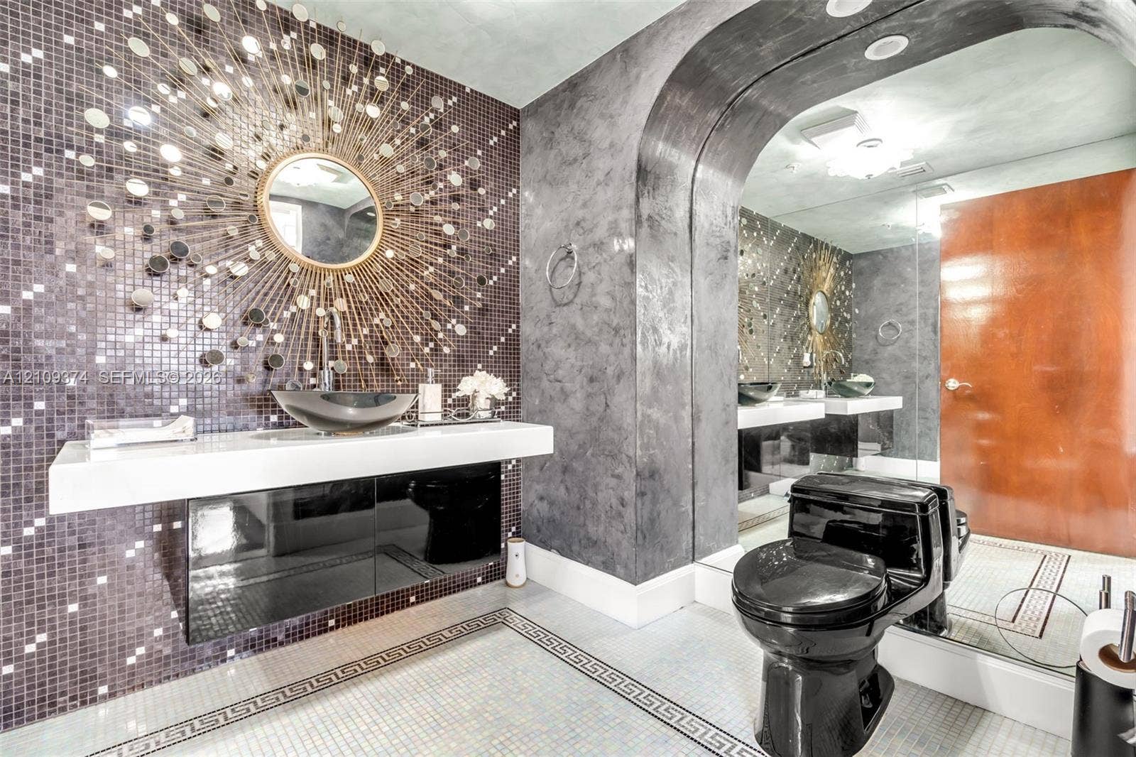 100 N Federal Highway, #1, Fort Lauderdale, FL 33301 Floating vanity featuring a thick white countertop, integrated basin, and black high-gloss cabinetry