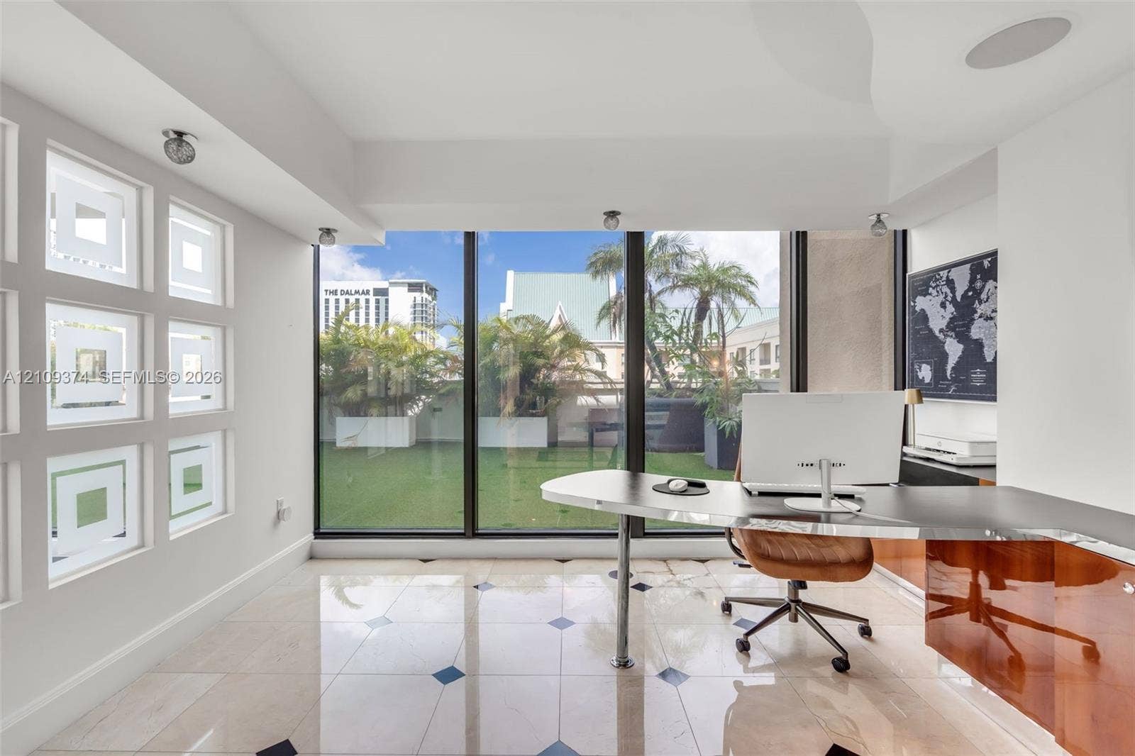 100 N Federal Highway, #1, Fort Lauderdale, FL 33301 Floor-to-ceiling windows, stone tile flooring with decorative inlay, built-in high-gloss cabinetry, recessed ceiling lighting, and custom geometric glass wall panels