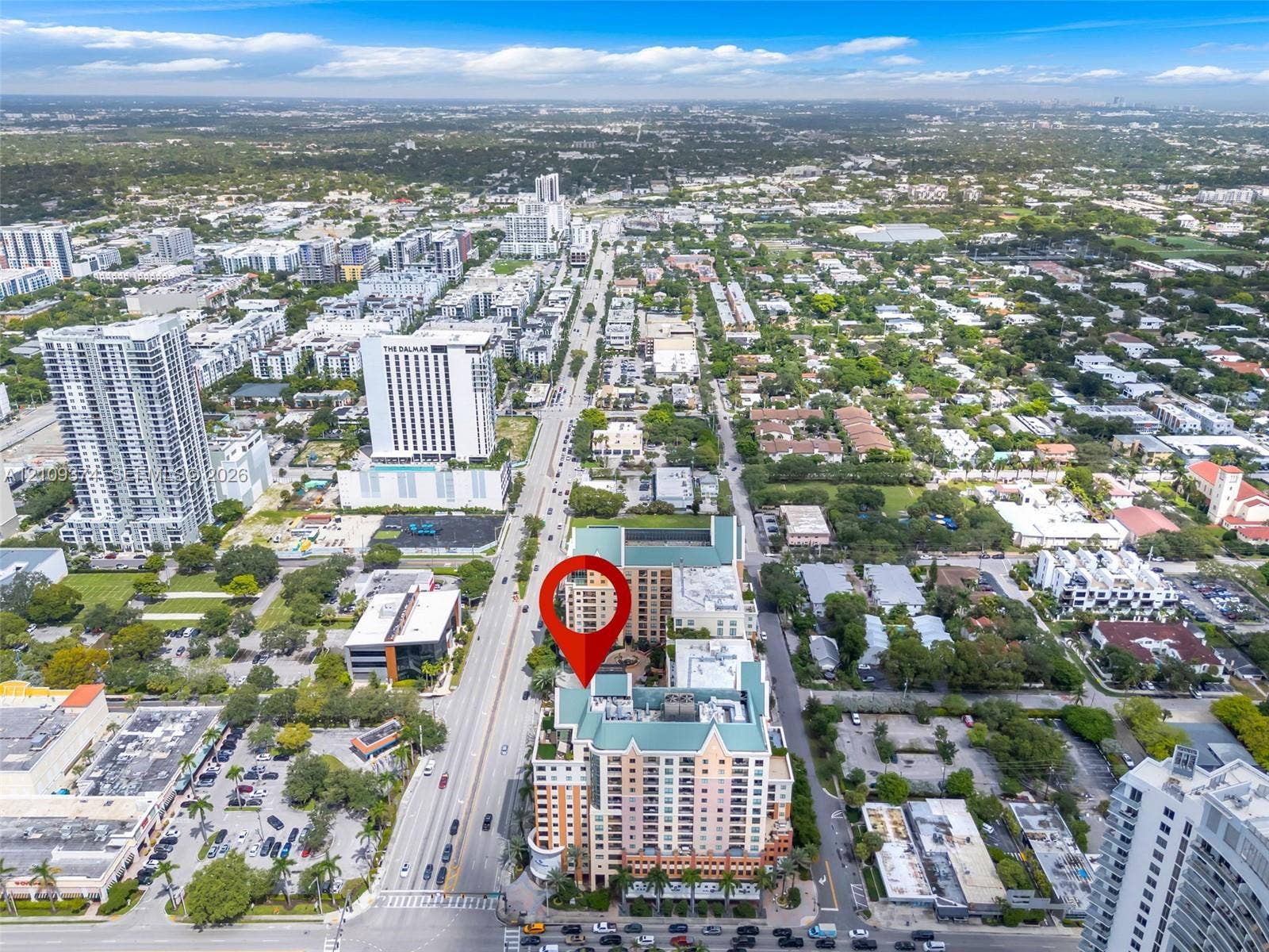 100 N Federal Highway, #1, Fort Lauderdale, FL 33301 Aerial perspective of high-rise building featuring a multi-story exterior, ground-level parking, and prominent location within an established metropolitan grid