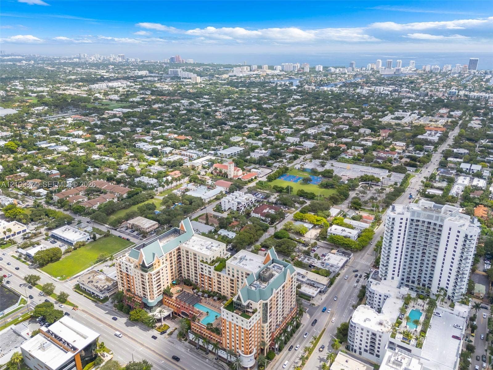 100 N Federal Highway, #1, Fort Lauderdale, FL 33301 Aerial view of multi-story residential building featuring a terracotta facade, steep pitched rooflines, and an outdoor swimming pool