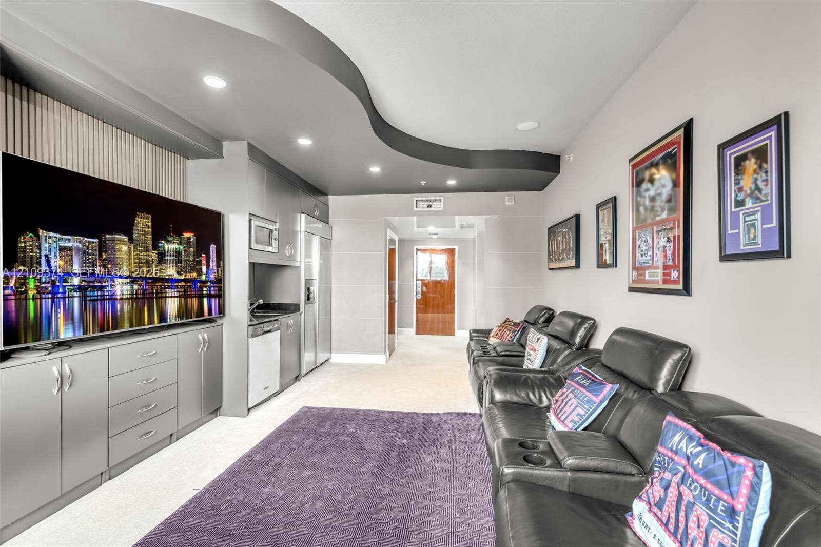 100 N Federal Highway, #1, Fort Lauderdale, FL 33301 Custom built-in cabinetry with integrated microwave, stainless steel refrigerator, dishwasher, recessed ceiling lighting, and a distinctive curved architectural ceiling feature