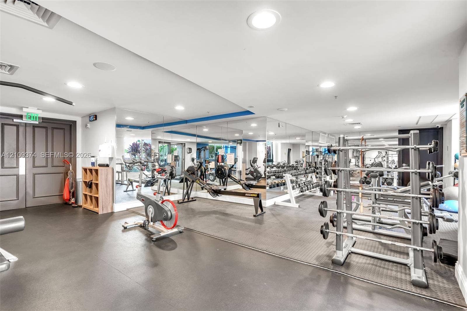 100 N Federal Highway, #1, Fort Lauderdale, FL 33301 Fitness facility featuring wall-to-wall mirrors, recessed lighting, double-door entry, and resilient rubber flooring