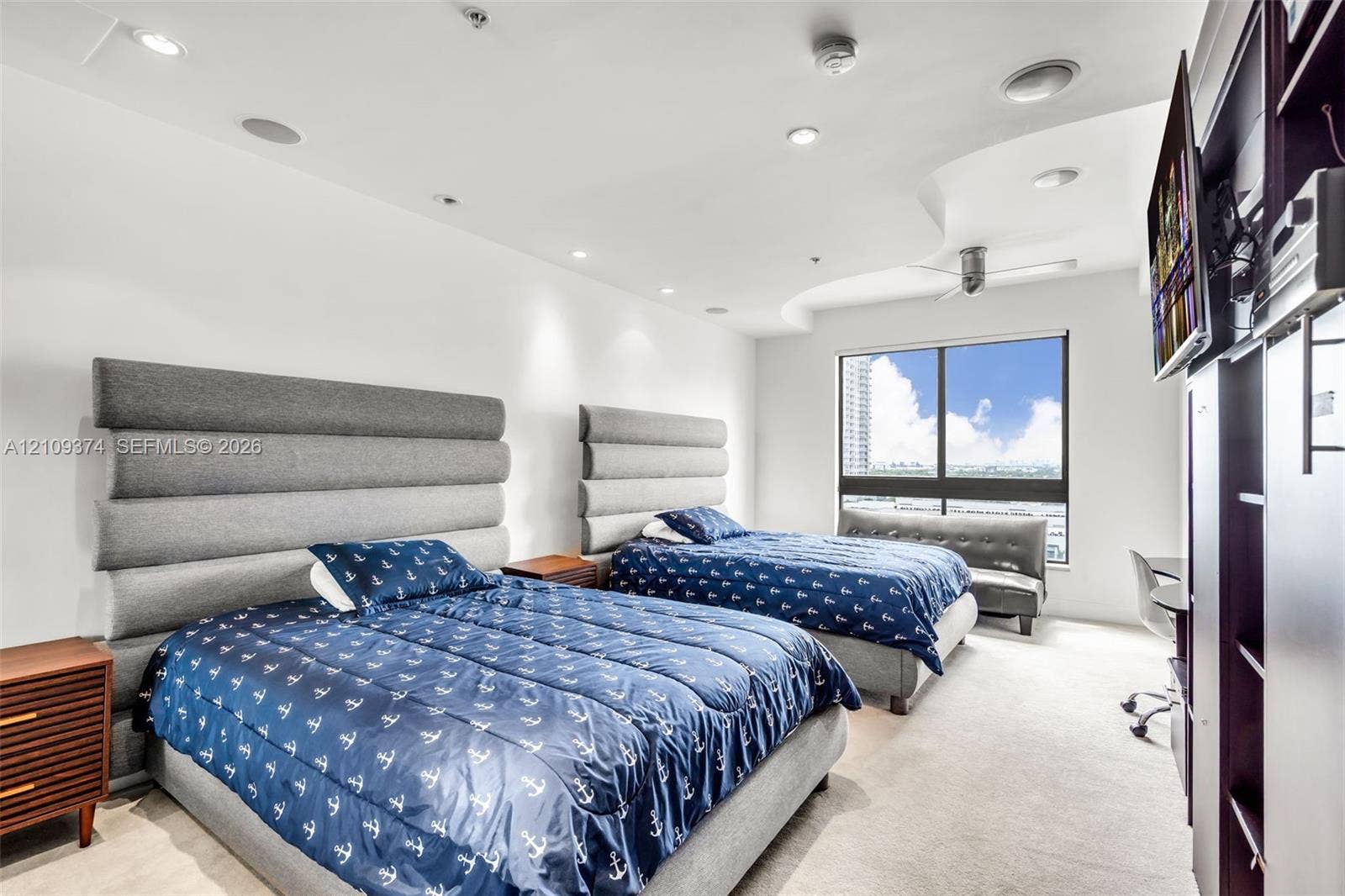 100 N Federal Highway, #1, Fort Lauderdale, FL 33301 Room featuring a recessed ceiling detail, ceiling-mounted light fixtures, wall-to-wall carpeting, and a large window