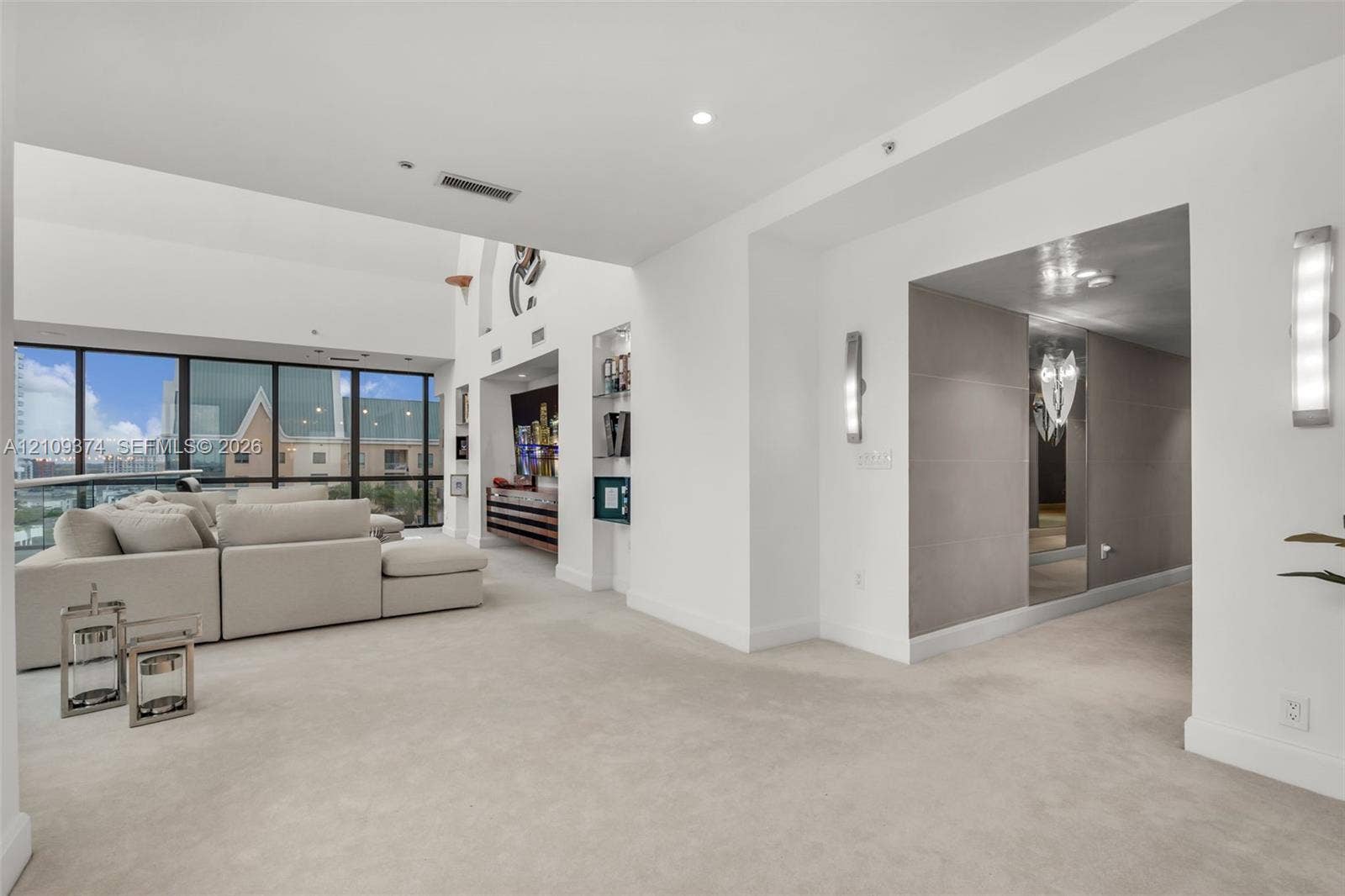 100 N Federal Highway, #1, Fort Lauderdale, FL 33301 Interior space featuring expansive floor-to-ceiling windows, recessed lighting, built-in wall shelving, and wall-mounted light fixtures