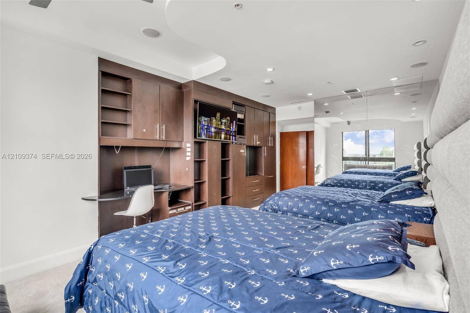 100 N Federal Highway, #1, Fort Lauderdale, FL 33301 Custom built-in cabinetry with integrated desk station, recessed ceiling lighting, and large window