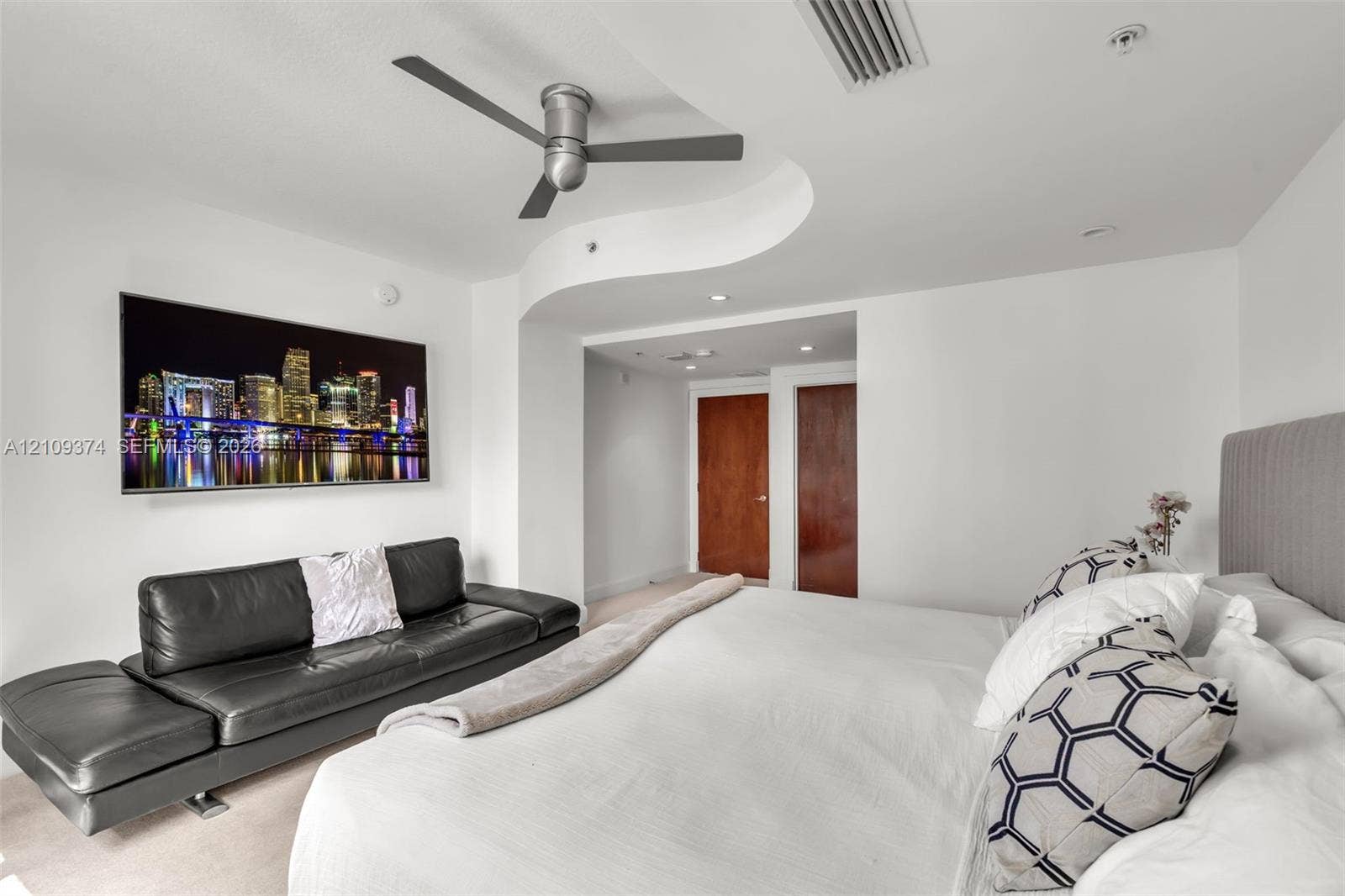 100 N Federal Highway, #1, Fort Lauderdale, FL 33301 Curved architectural ceiling detail, dark-finish ceiling fan, recessed lighting, and solid-core wooden doors