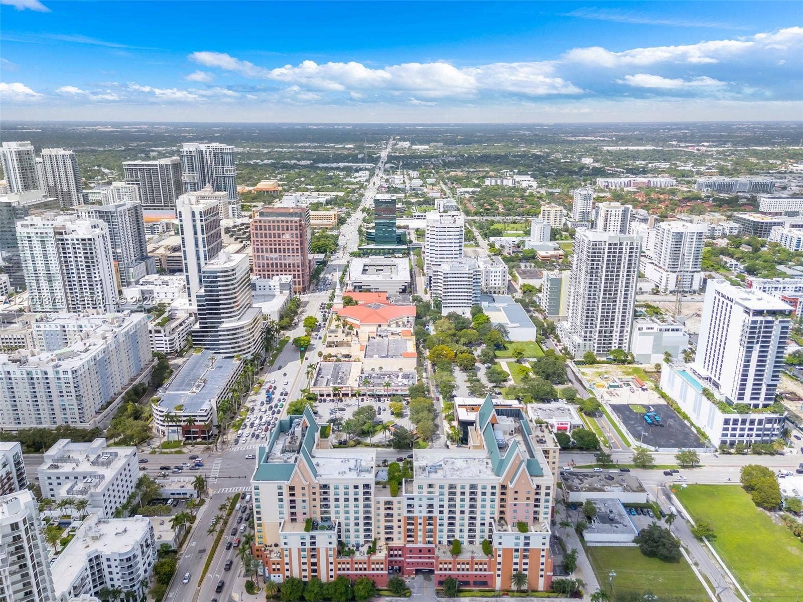 100 N Federal Highway, #1, Fort Lauderdale, FL 33301 Aerial perspective of a high-rise urban center featuring multi-story residential buildings, commercial structures, structured parking facilities, and interconnected street networks