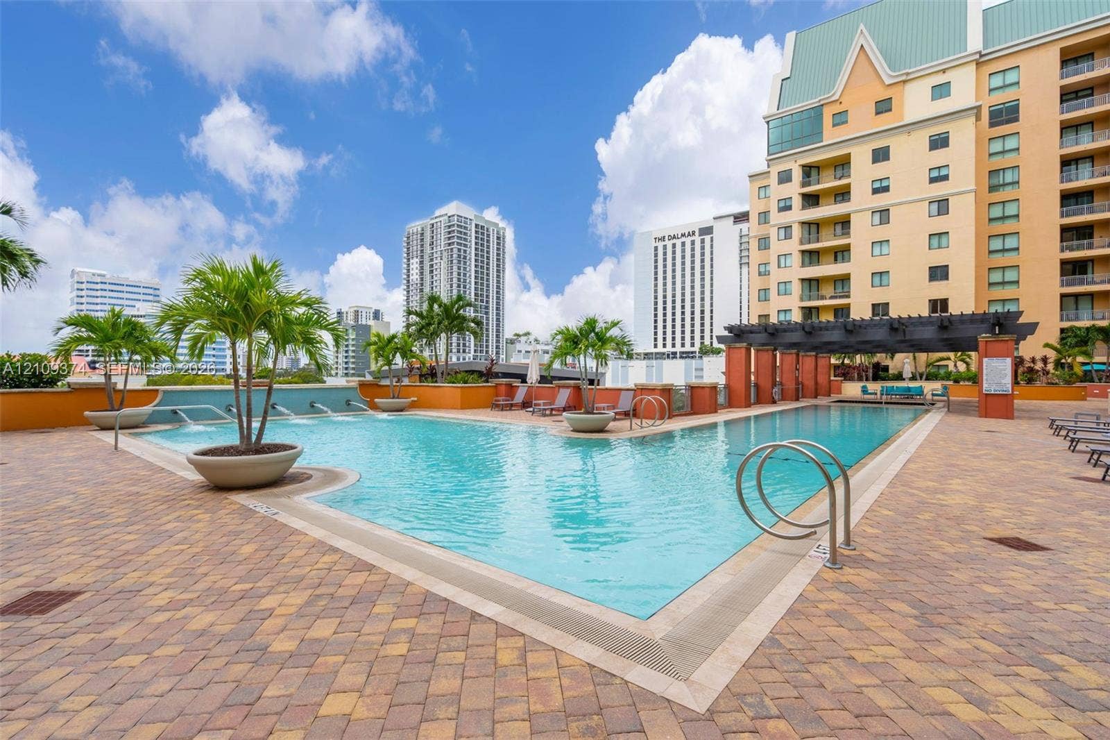 100 N Federal Highway, #1, Fort Lauderdale, FL 33301 Swimming pool featuring integrated water features, a paver deck, and a shaded pergola structure