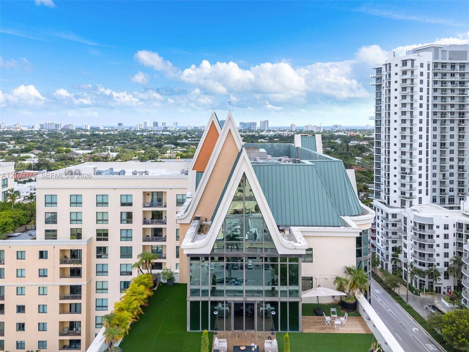 100 N Federal Highway, #1, Fort Lauderdale, FL 33301 High-rise penthouse featuring an A-frame architectural design, expansive glass curtain wall, metal roofing, and a private rooftop terrace with artificial turf