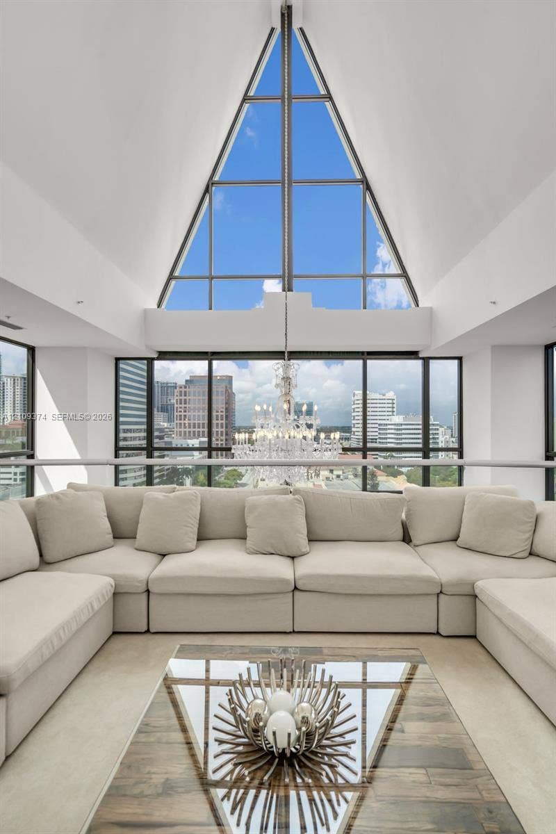 100 N Federal Highway, #1, Fort Lauderdale, FL 33301 Vaulted A-frame ceiling with floor-to-ceiling triangular window, expansive glass window walls, and built-in crystal chandelier