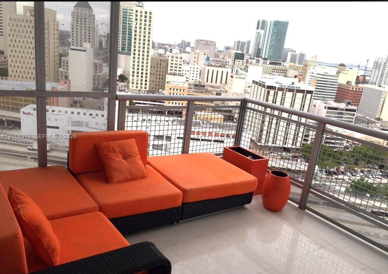 350 S Miami Avenue, #2207, Miami, Miami, FL 33130 Covered balcony featuring large-format tile flooring and metal railing with wire mesh infill panels