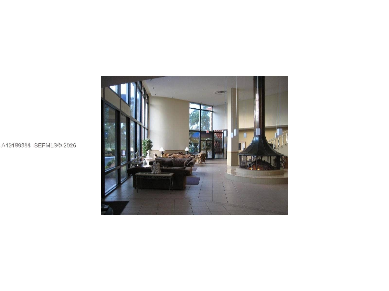 26 Diplomat Parkway, #2351, Hallandale Beach, FL 33009 Floor-to-ceiling windows, circular suspended metal fireplace, tiled flooring, high ceilings, and recessed lighting