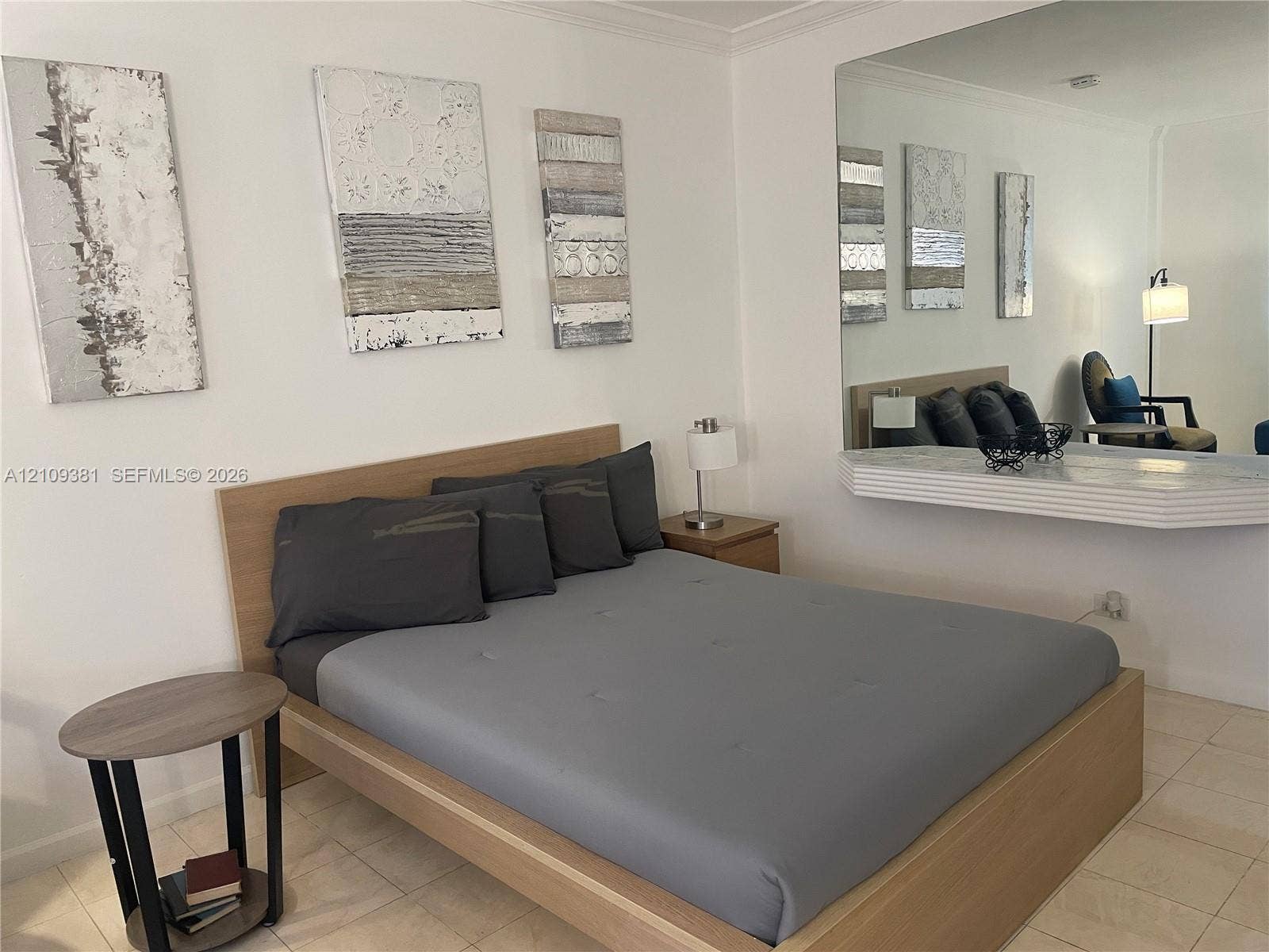 26 Diplomat Parkway, #2351, Hallandale Beach, FL 33009 Large wall-mounted mirror featuring a wide, integrated shelf with a molded edge and tile flooring