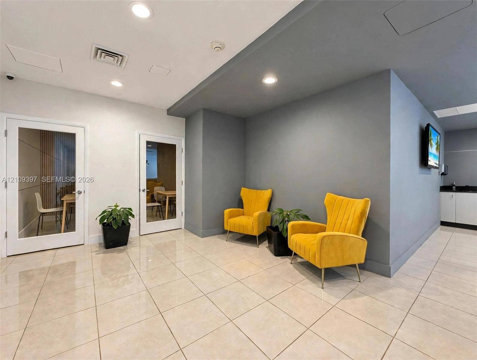 Ceramic tile flooring, recessed lighting, and two interior doors with glass inserts