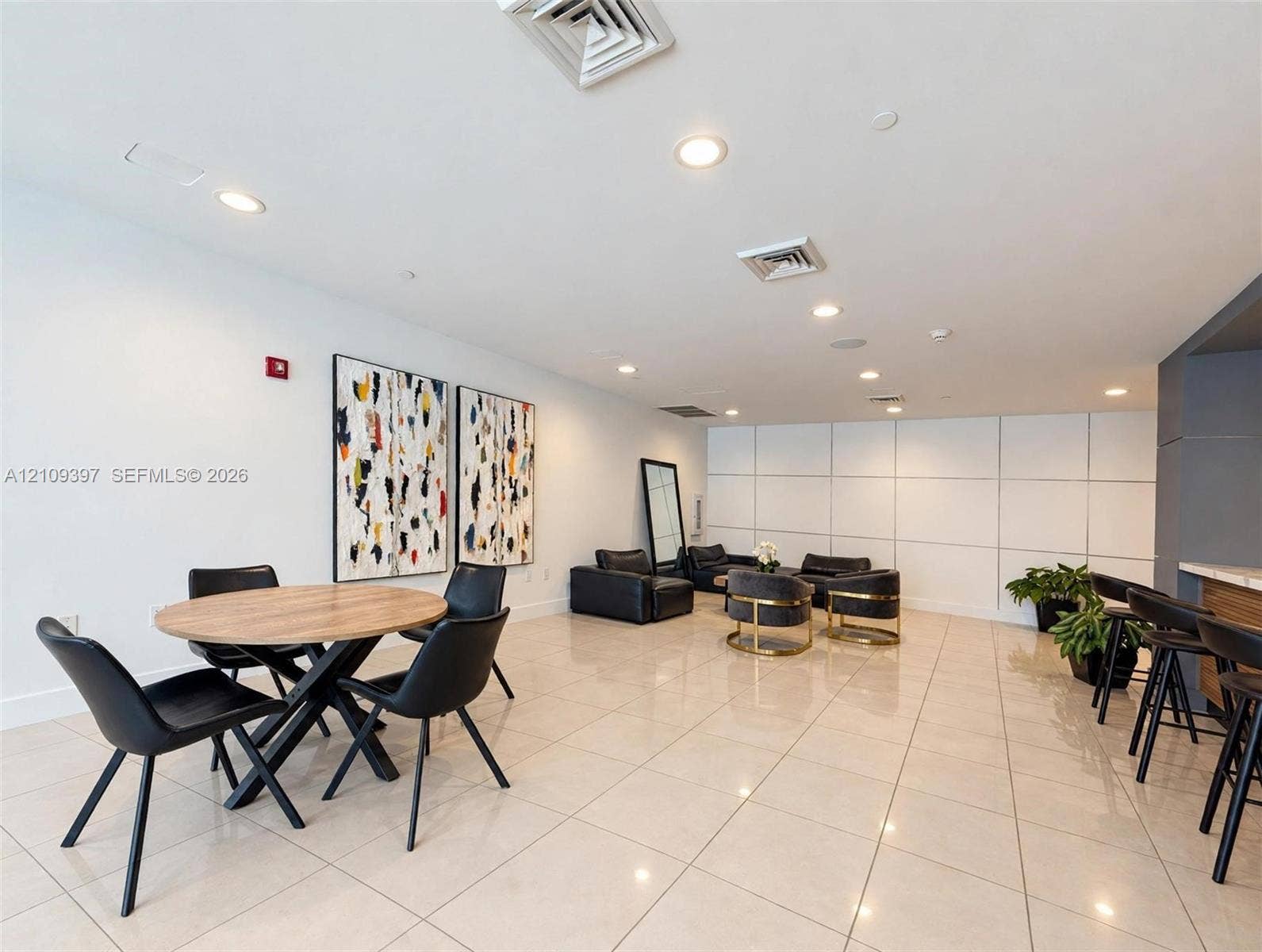 Neutral-toned tile flooring, recessed ceiling lighting, and large-scale wall paneling