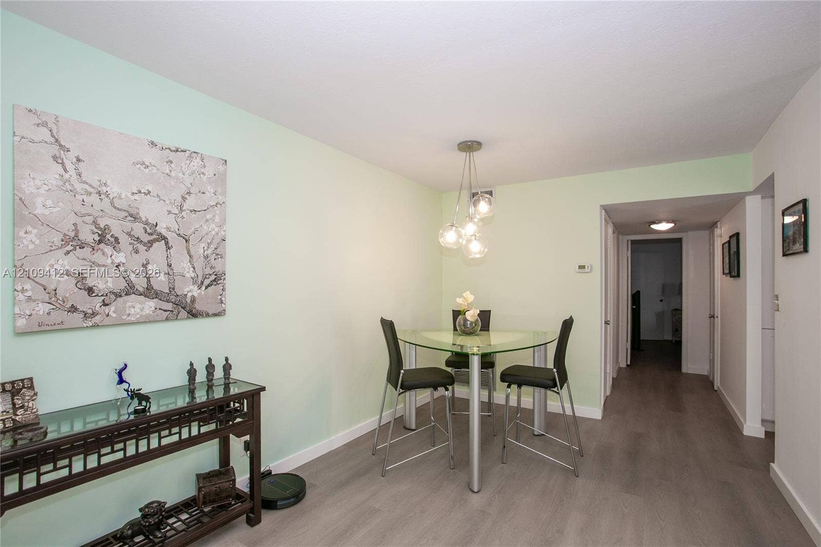137 Golden Isles Drive, #408, Hallandale Beach, FL 33009 Interior space featuring wood-finish flooring and a multi-bulb spherical pendant light fixture