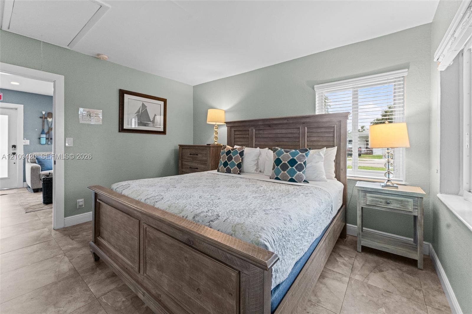 1955 Thomas Street, Hollywood, FL 33020 Ceramic tile flooring, horizontal window blinds, and interior doors with decorative hardware
