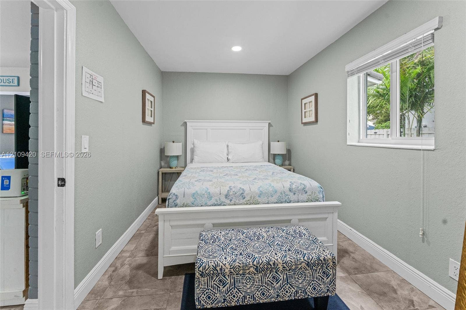 1955 Thomas Street, Hollywood, FL 33020 Neutral wall-toned room featuring stone-finish floor tiling and a single-pane sliding window