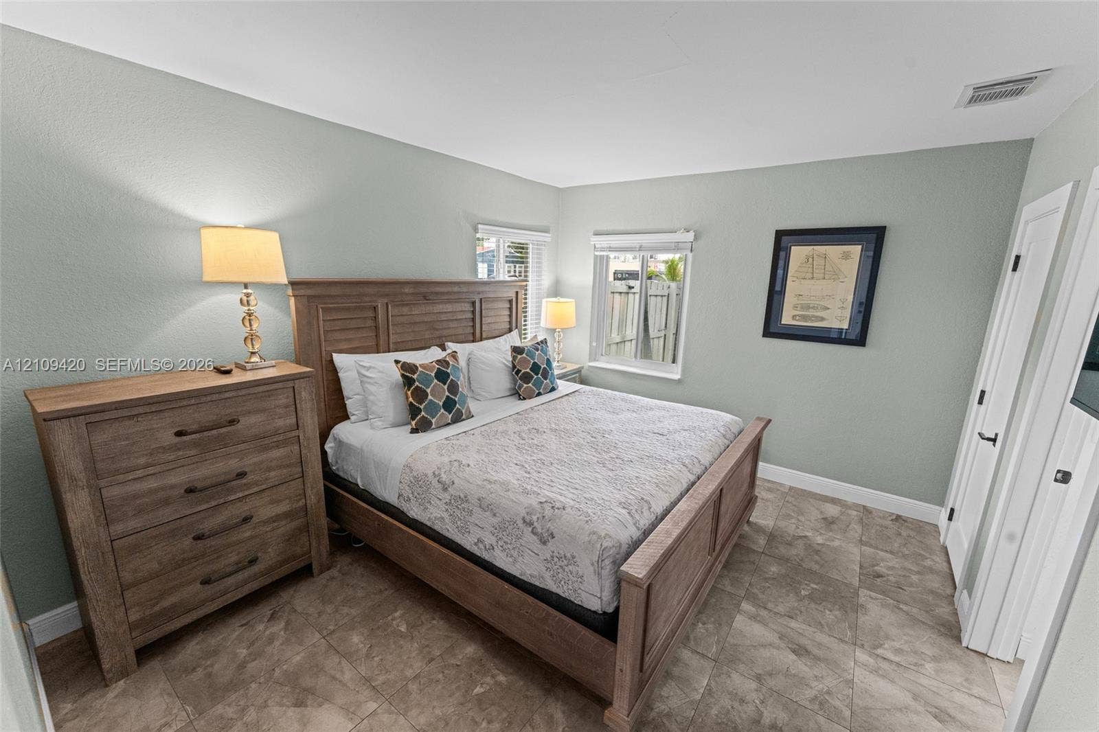 1955 Thomas Street, Hollywood, FL 33020 Neutral-toned wall finish, large-format tile flooring, and dual-pane windows with horizontal blinds