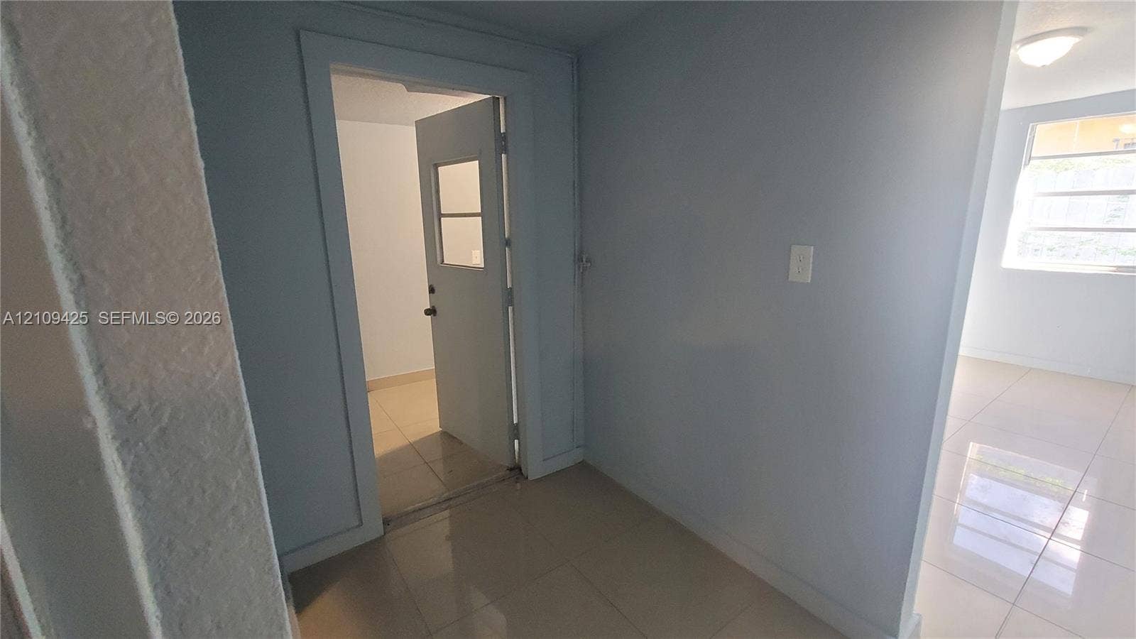 615 NW 25th Court, #B, Miami, Miami, FL 33125 Large-format tile flooring, single-light door with inset window, and recessed ceiling lighting