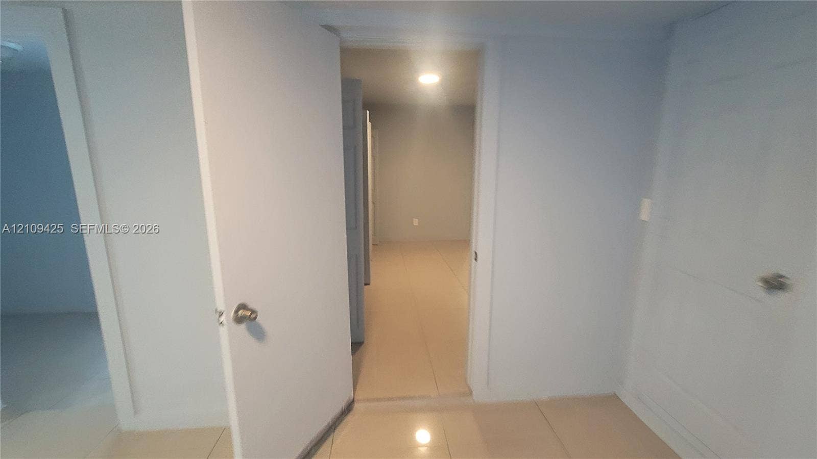 615 NW 25th Court, #B, Miami, Miami, FL 33125 Neutral interior featuring light-toned large format tile flooring, recessed ceiling lighting, and solid core doors with satin nickel hardware